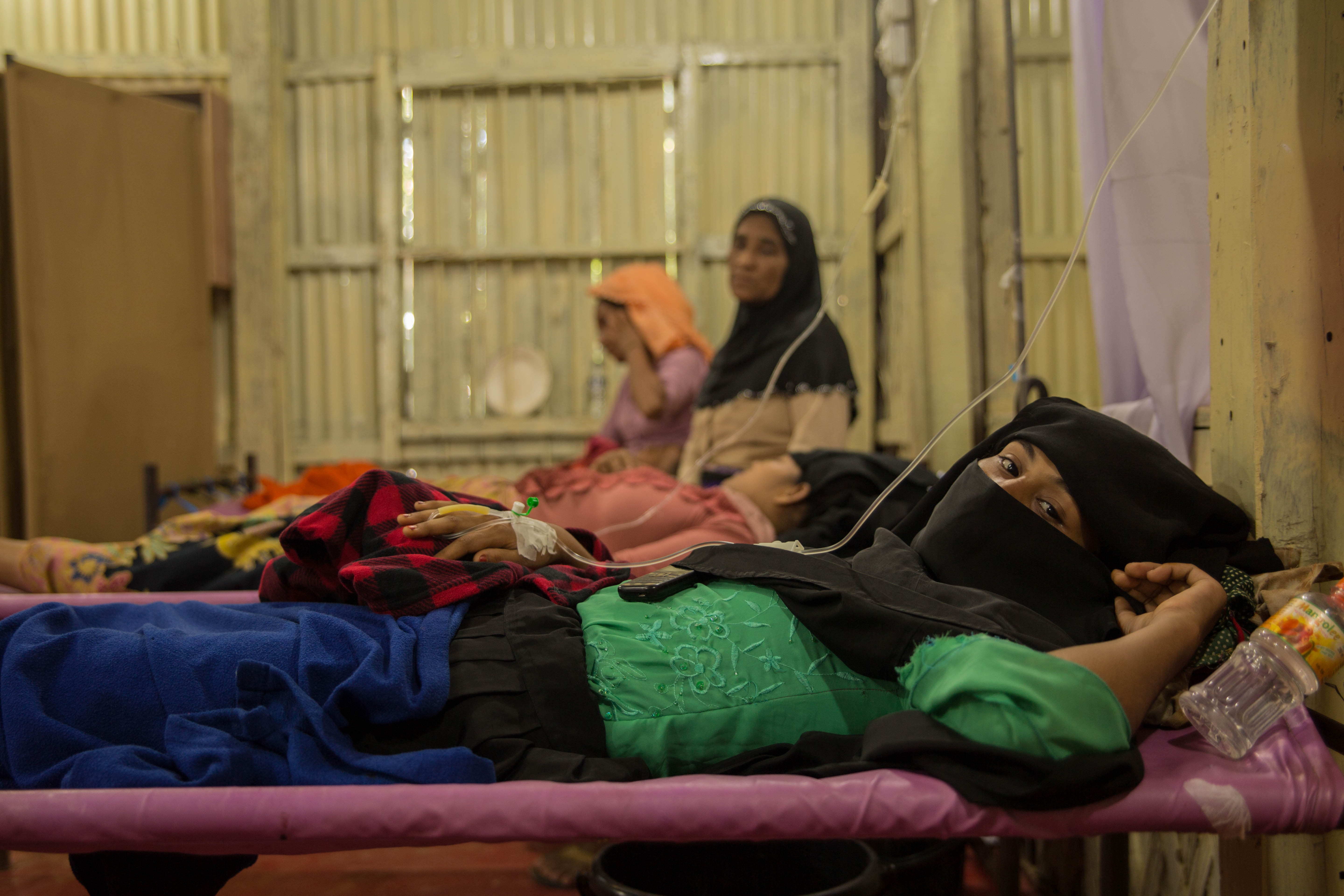 Women lie on hospital beds