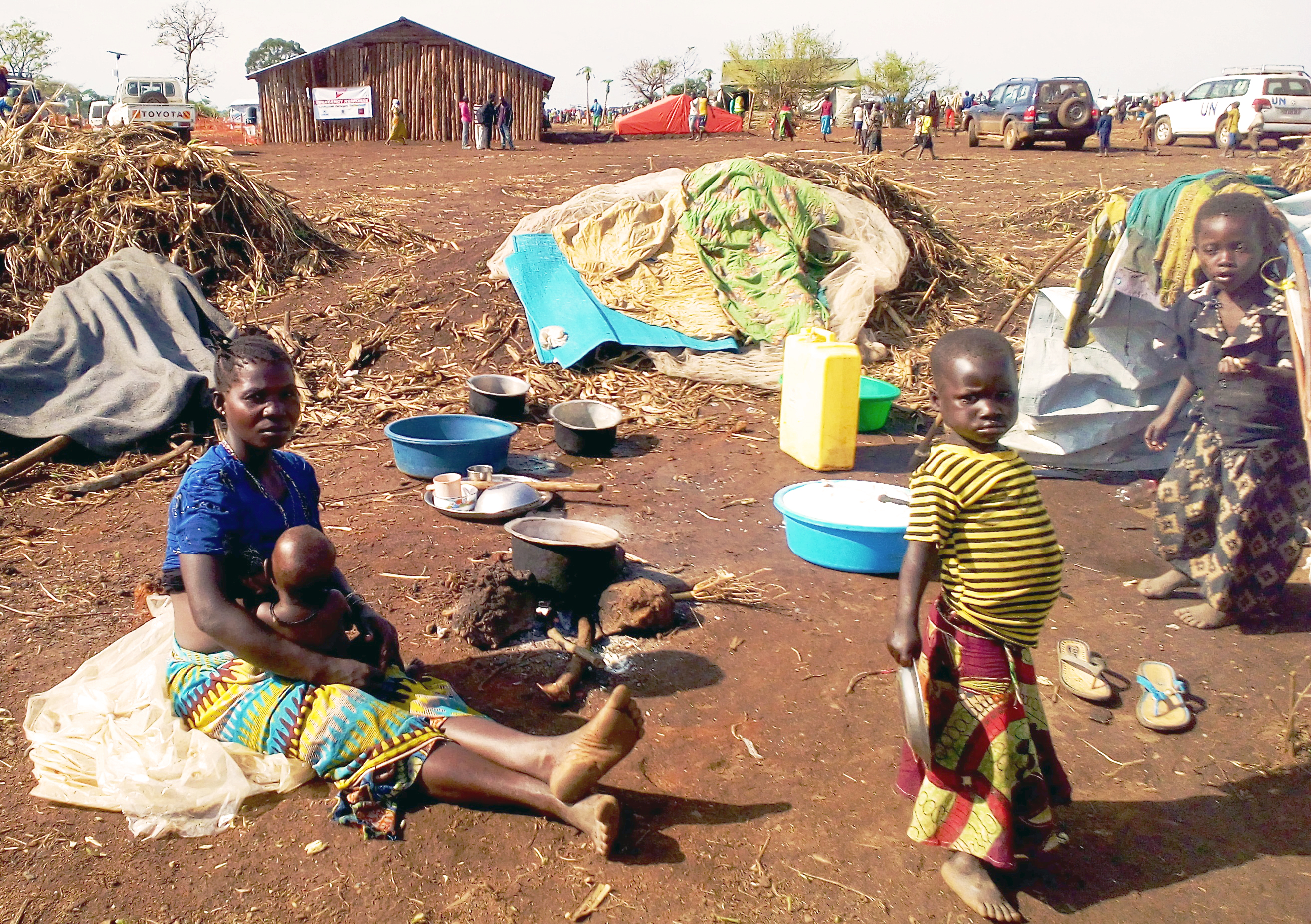 A young female refugee from Ituri Province carrying their baby at the back at Maratatu camp, Kyangwali refugee settlement in Hoima district