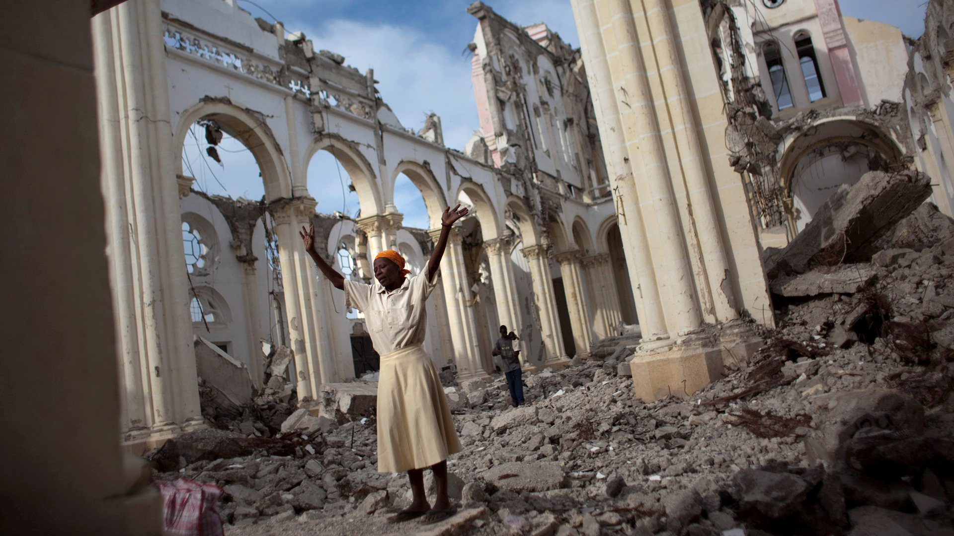 A woman prays among the rubble of the Cathedral of Our Lady of the Assumption that got destroyed in the 12 January 2010 earthquake in Port-au-Prince, Haiti.