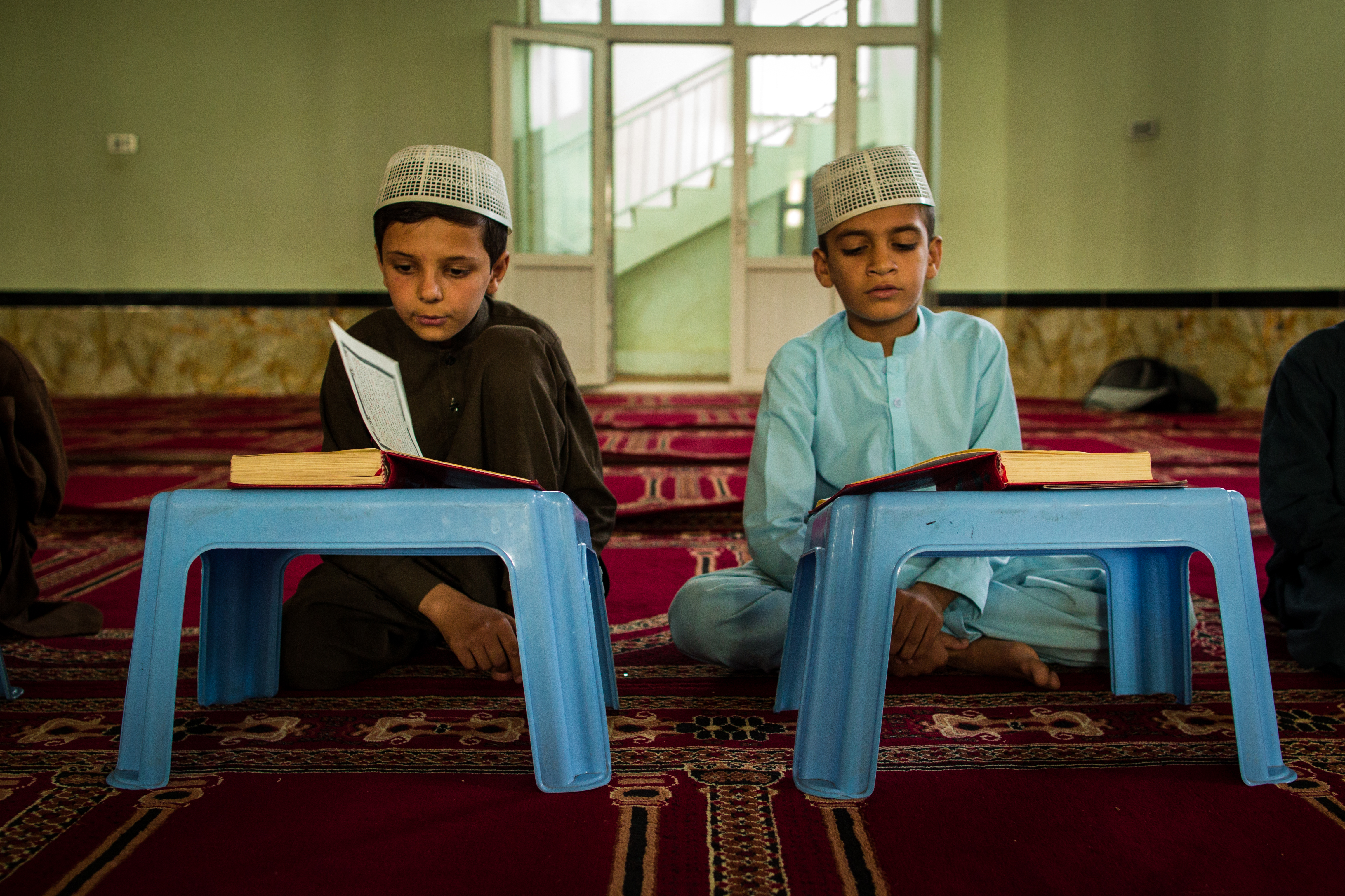 Two children reading at a mosque in Kabul