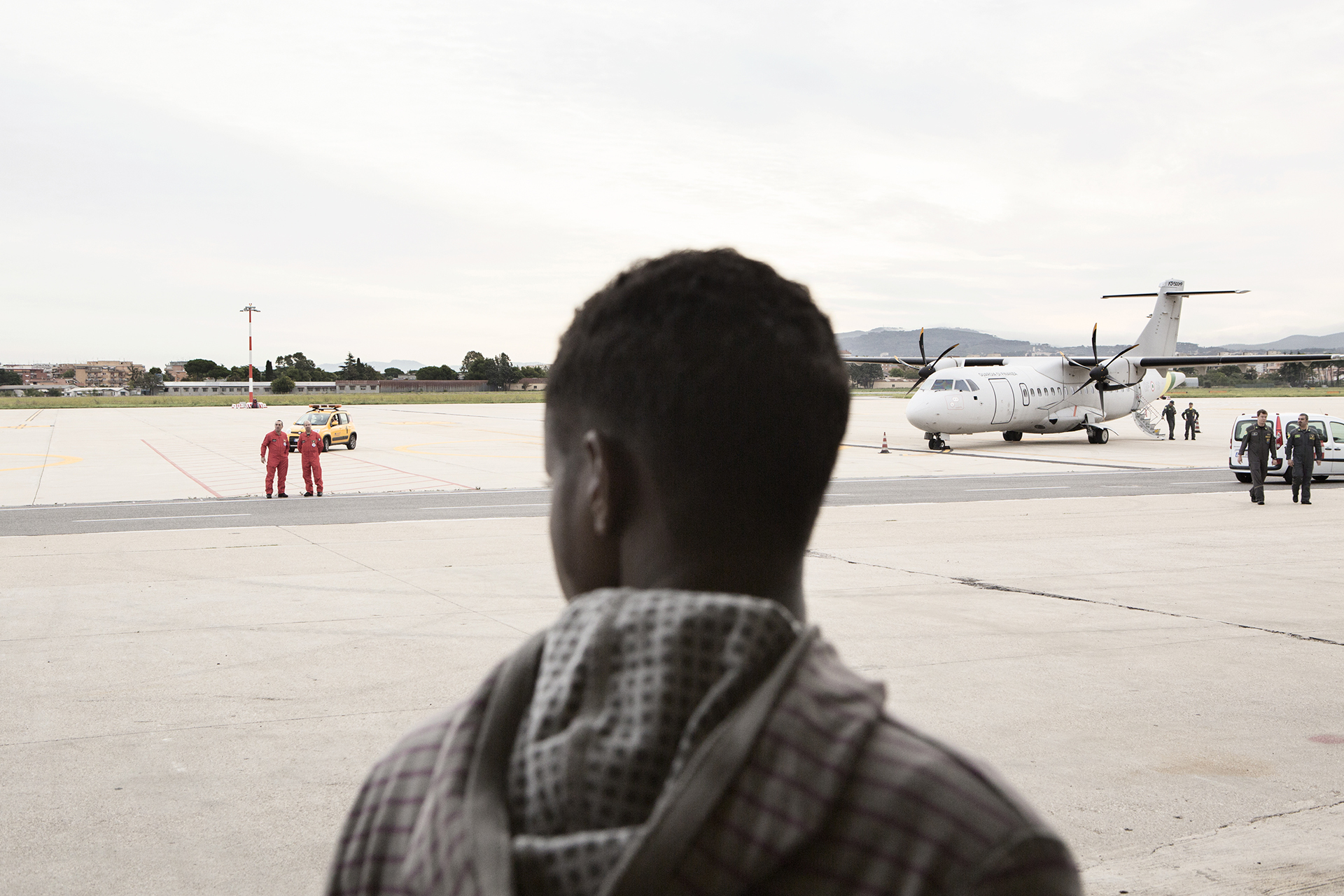 The back of a man's head on a tarmac