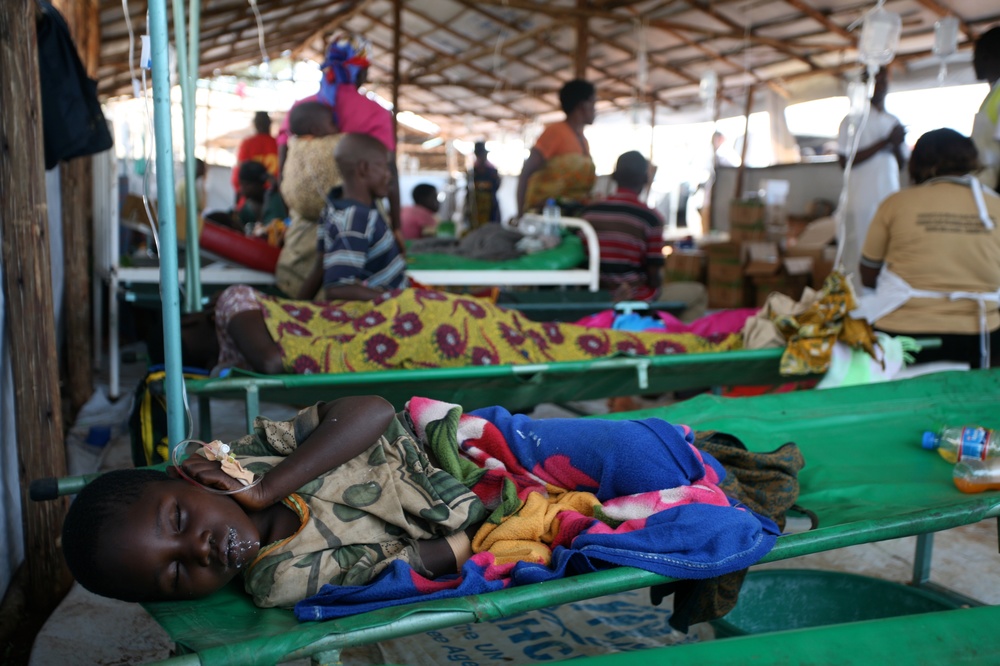 A child recovers from the journey and sleeps in the health clinic at Lake Tanganyika Stadium in Kigoma, Tanzania