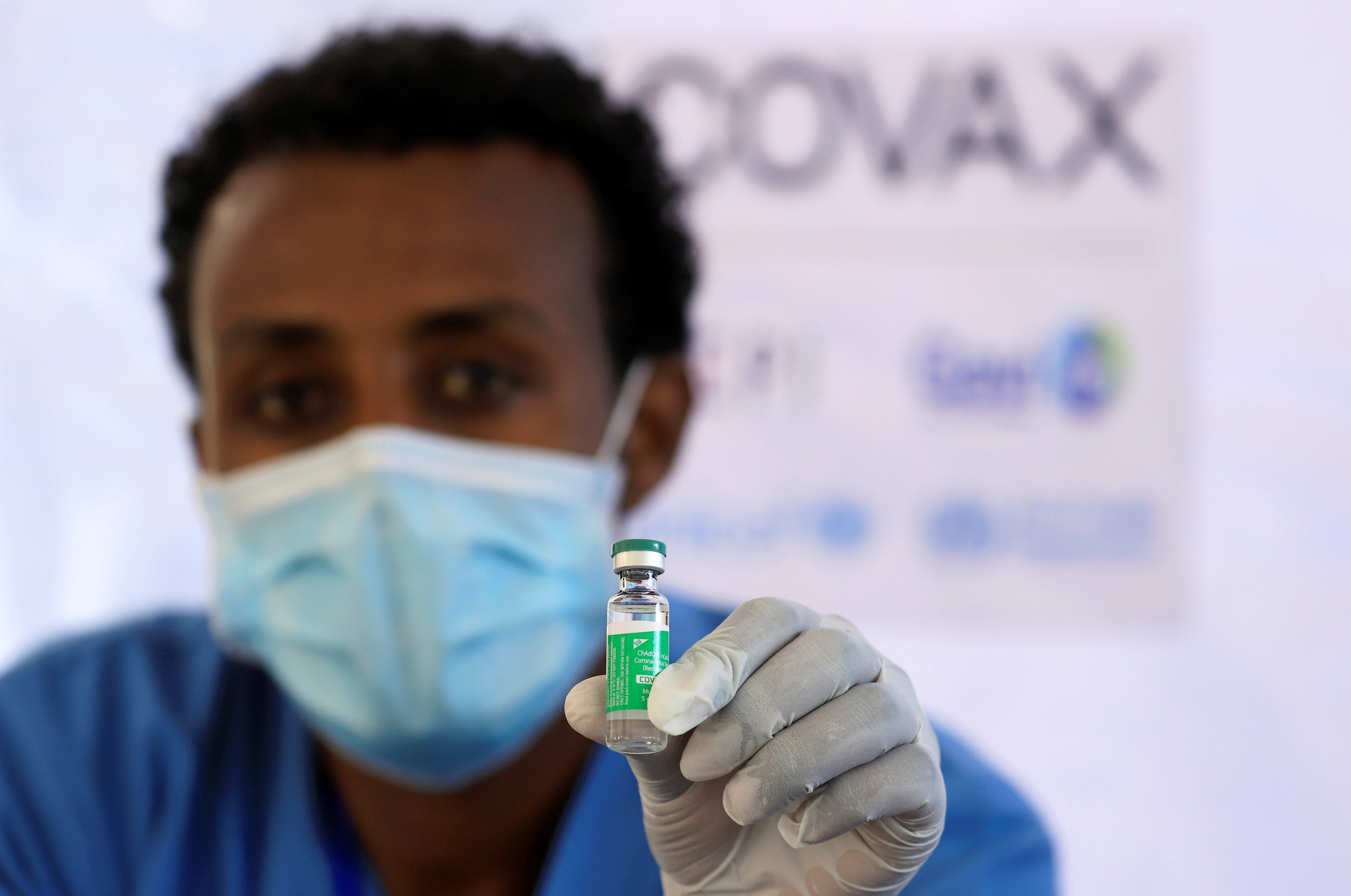 A nurse displays the AstraZeneca/Oxford vaccine.