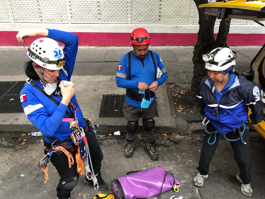 A group of rescue workers gets ready for their second shift at a five story office building in Mexico City.
