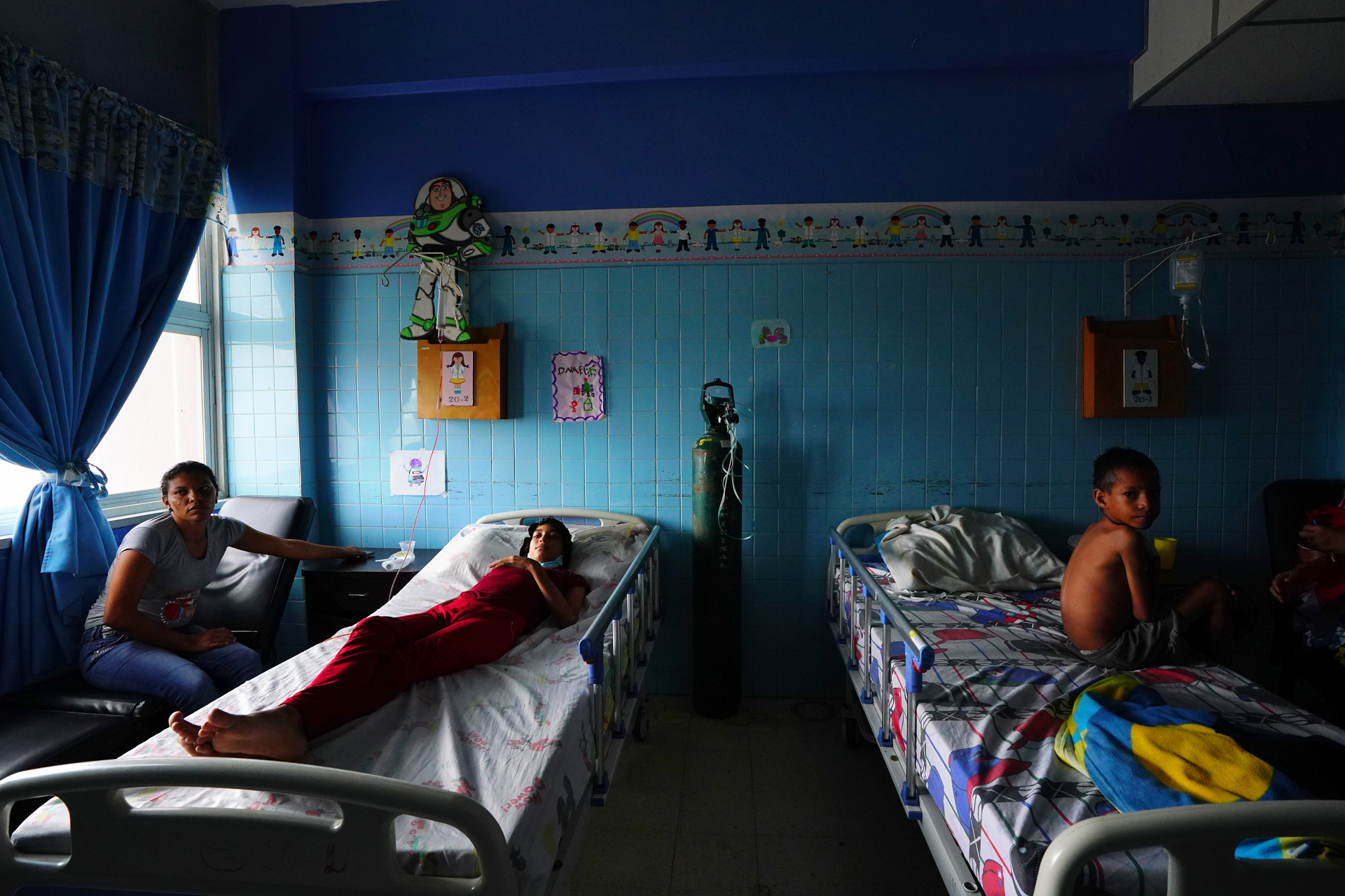 A blue room with hospital beds and decorations for children