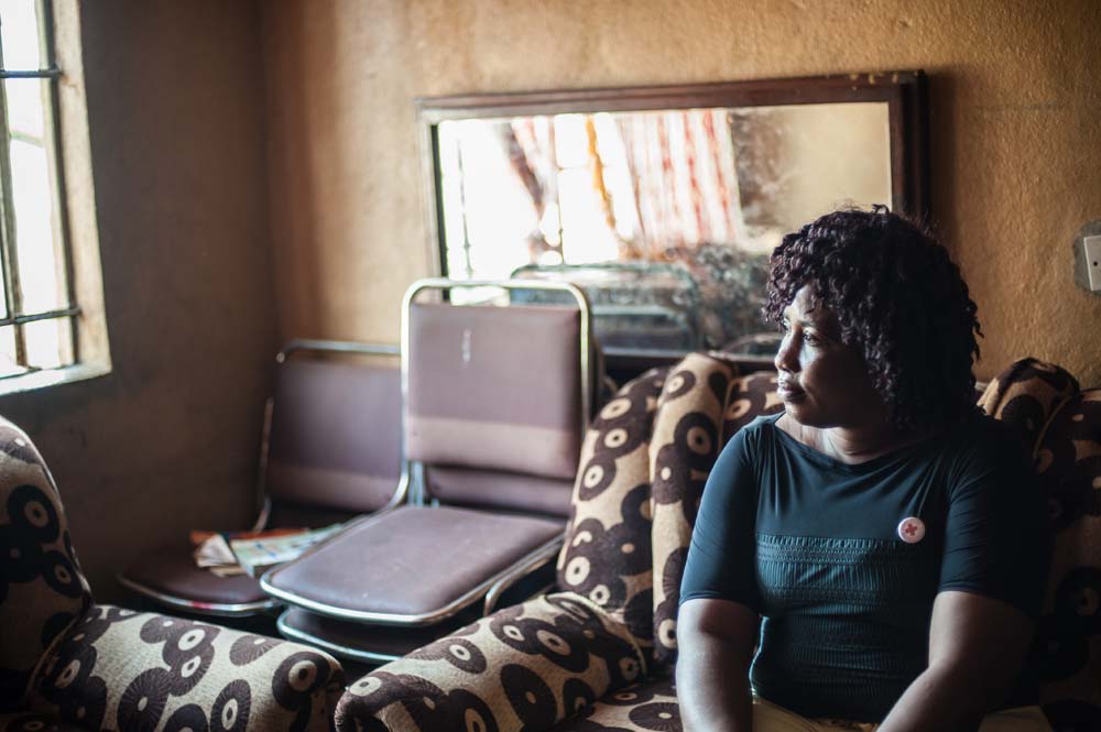 Kargbo, an ebola burial worker, sits in her lounge in Wellington, Sierra Leone