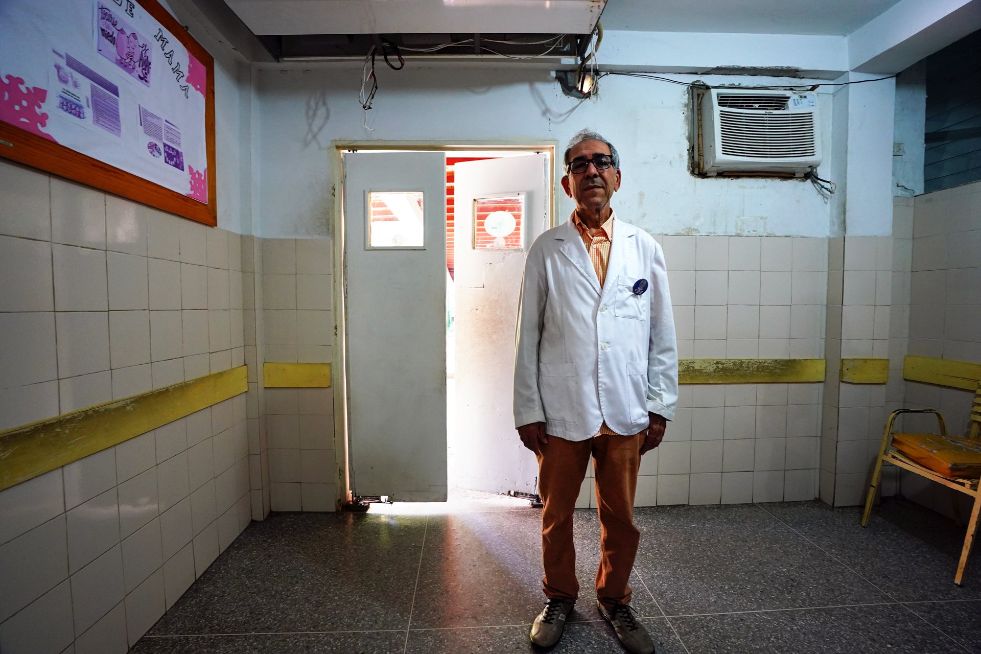 A wide shot of a doctor in a side room of a hospital