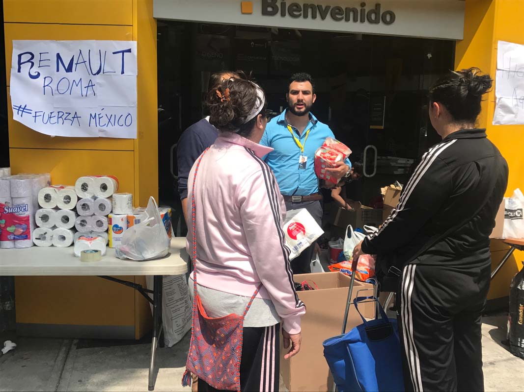Volunteers at a car dealership in Mexico City helping after the earthquake.