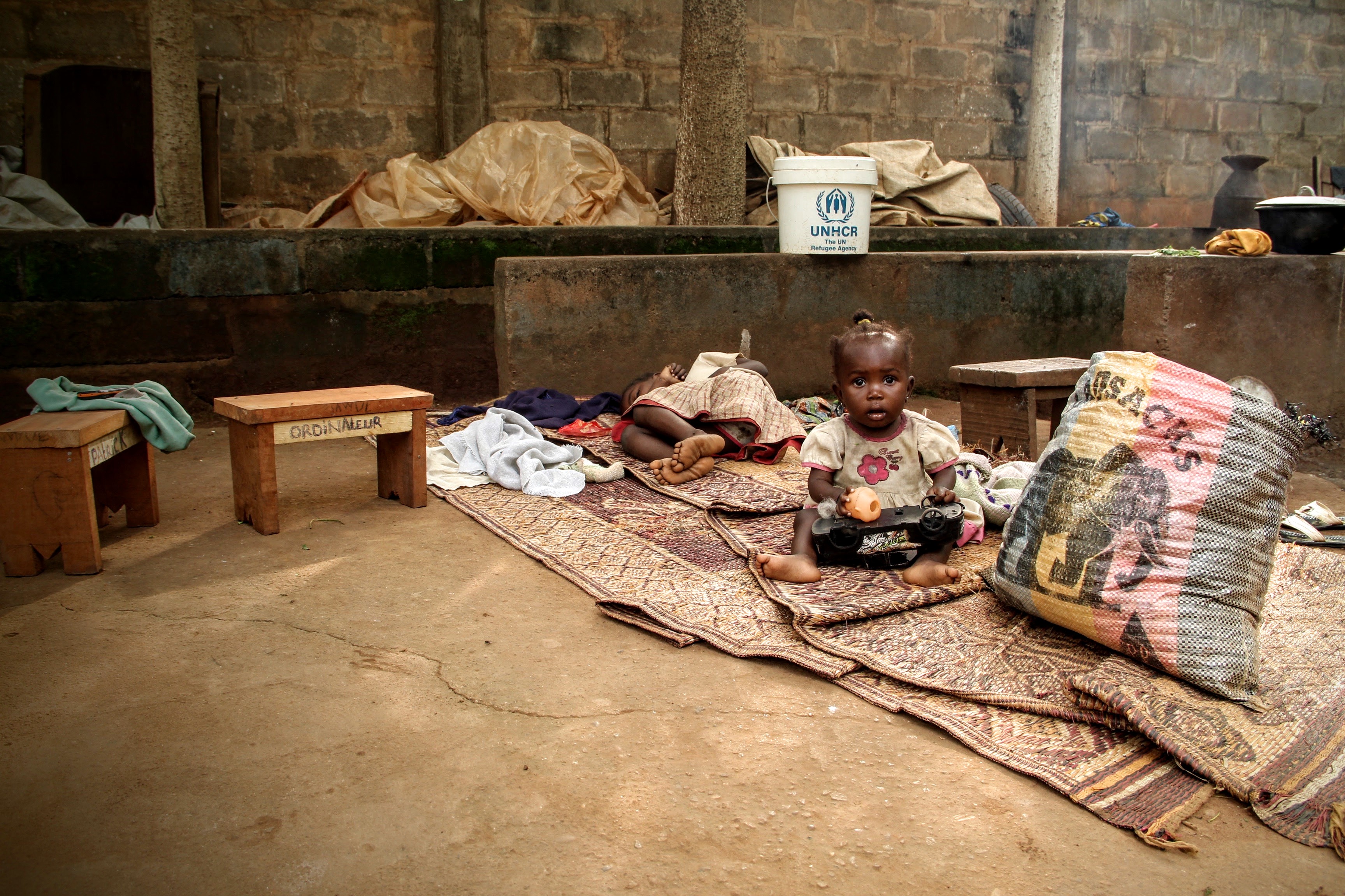 Children sleep and play in the Fatima church compound