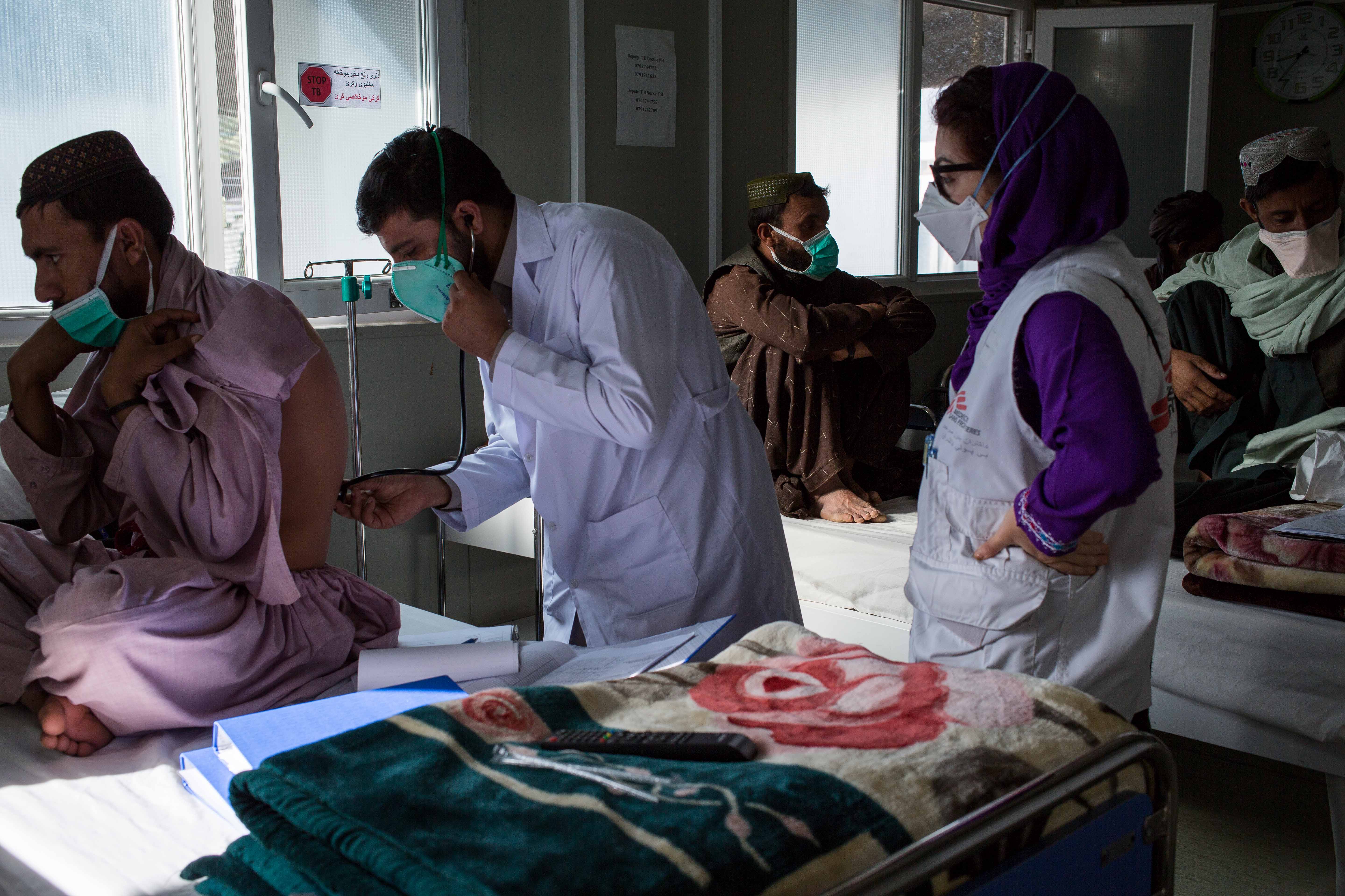 Health workers attend to patients at a tuberculosis clinic in Kandahar, Afghanistan
