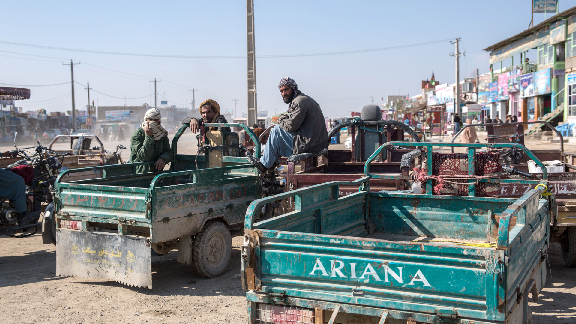 Drivers wait to take people on a route leading back to Iran in Zaranj, a border town in southwestern Afghanistan in January 2020. Nearly 860,000 Afghans returned from Iran in 2020.