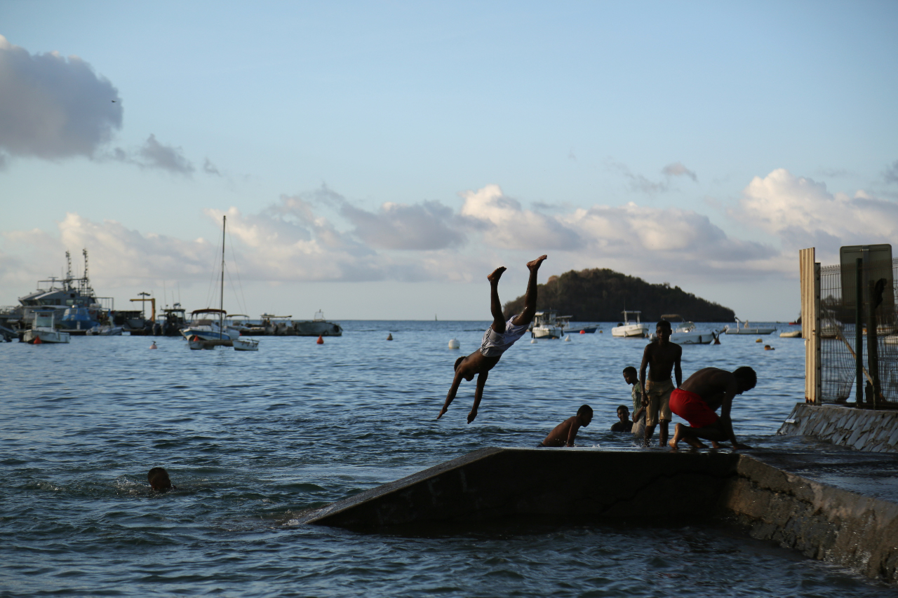 People jump into the sea on the French overseas island of Mayotte.