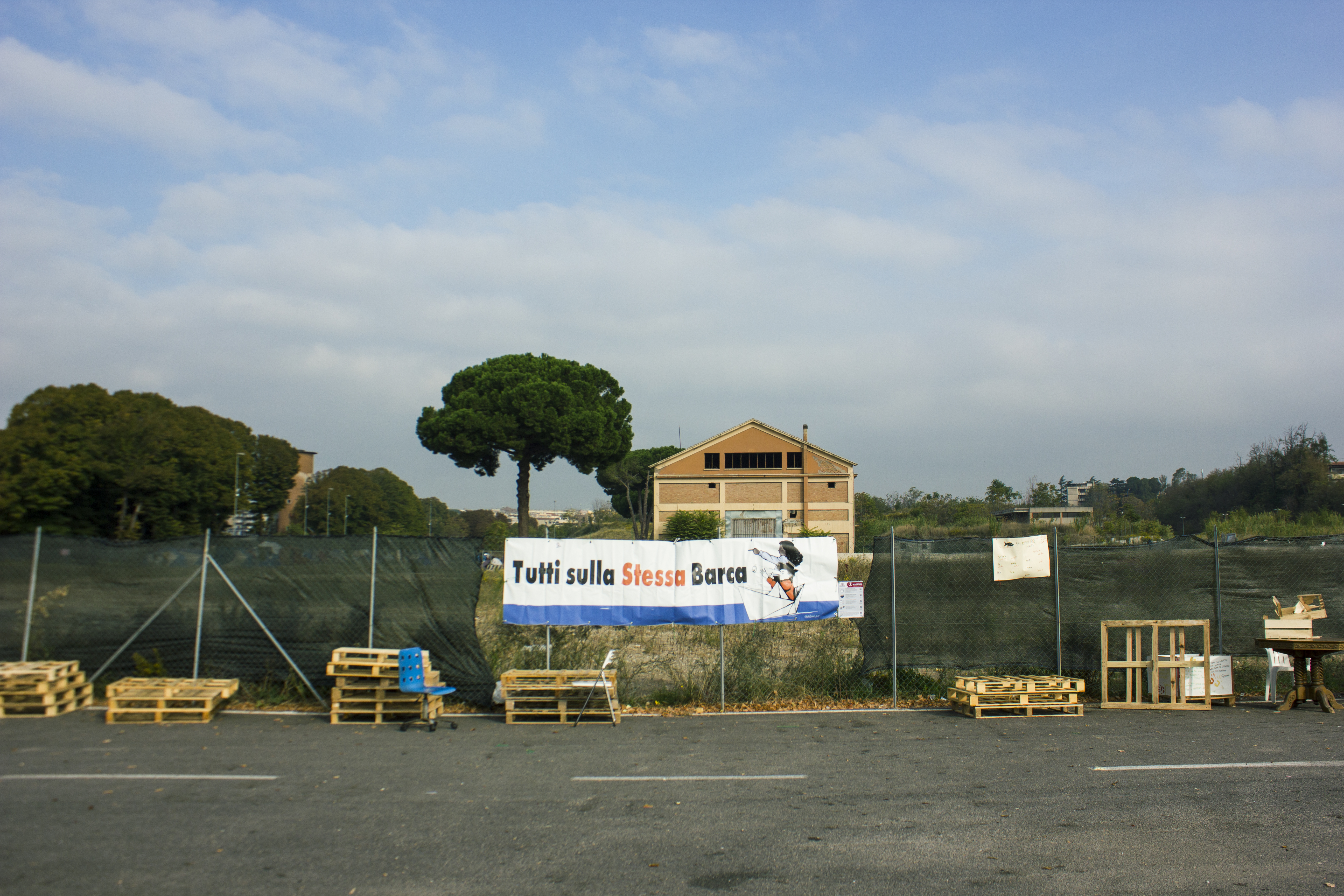 A parking lot with a banner up that reads