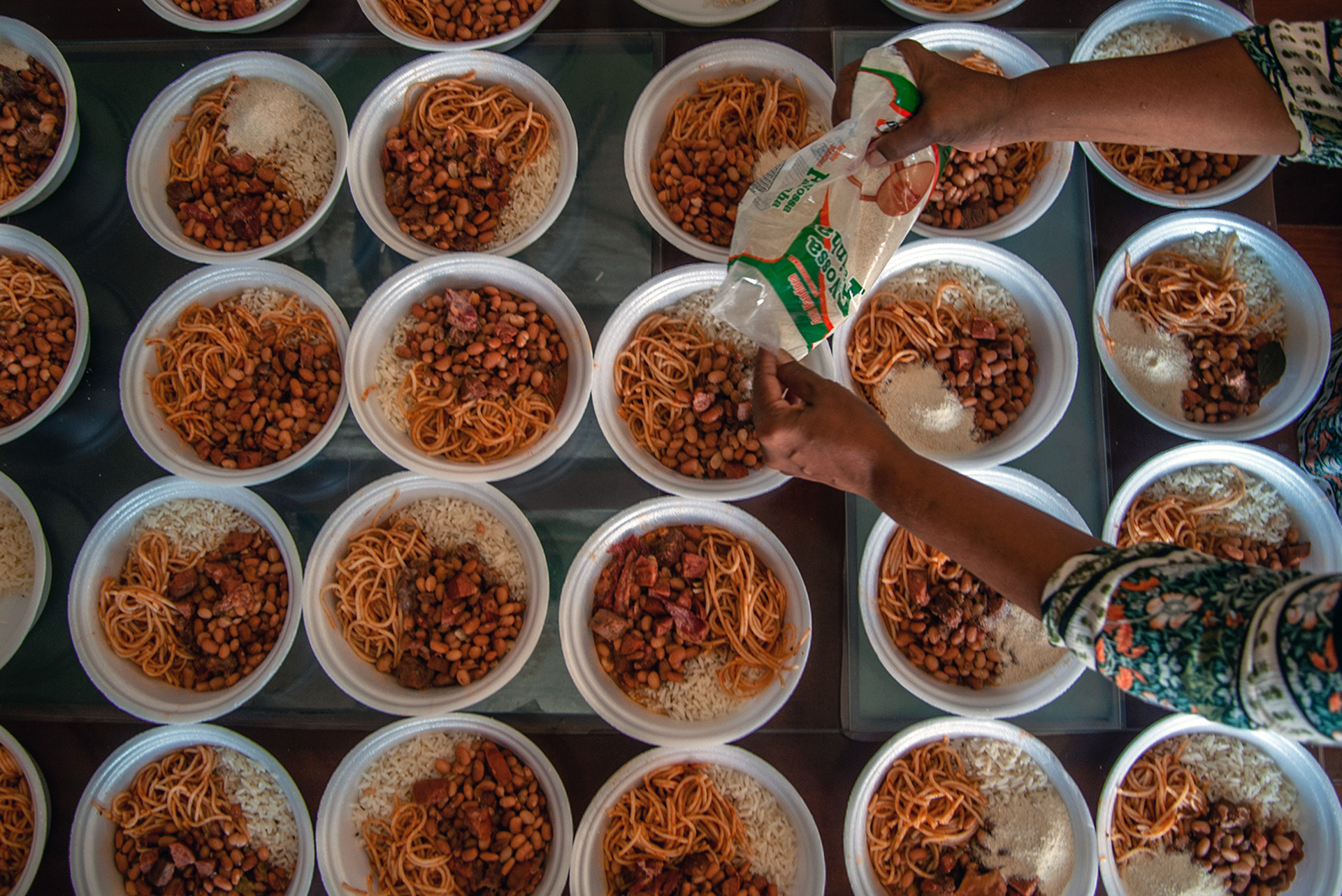 Meals are prepared by an informal community aid group in Salvador.