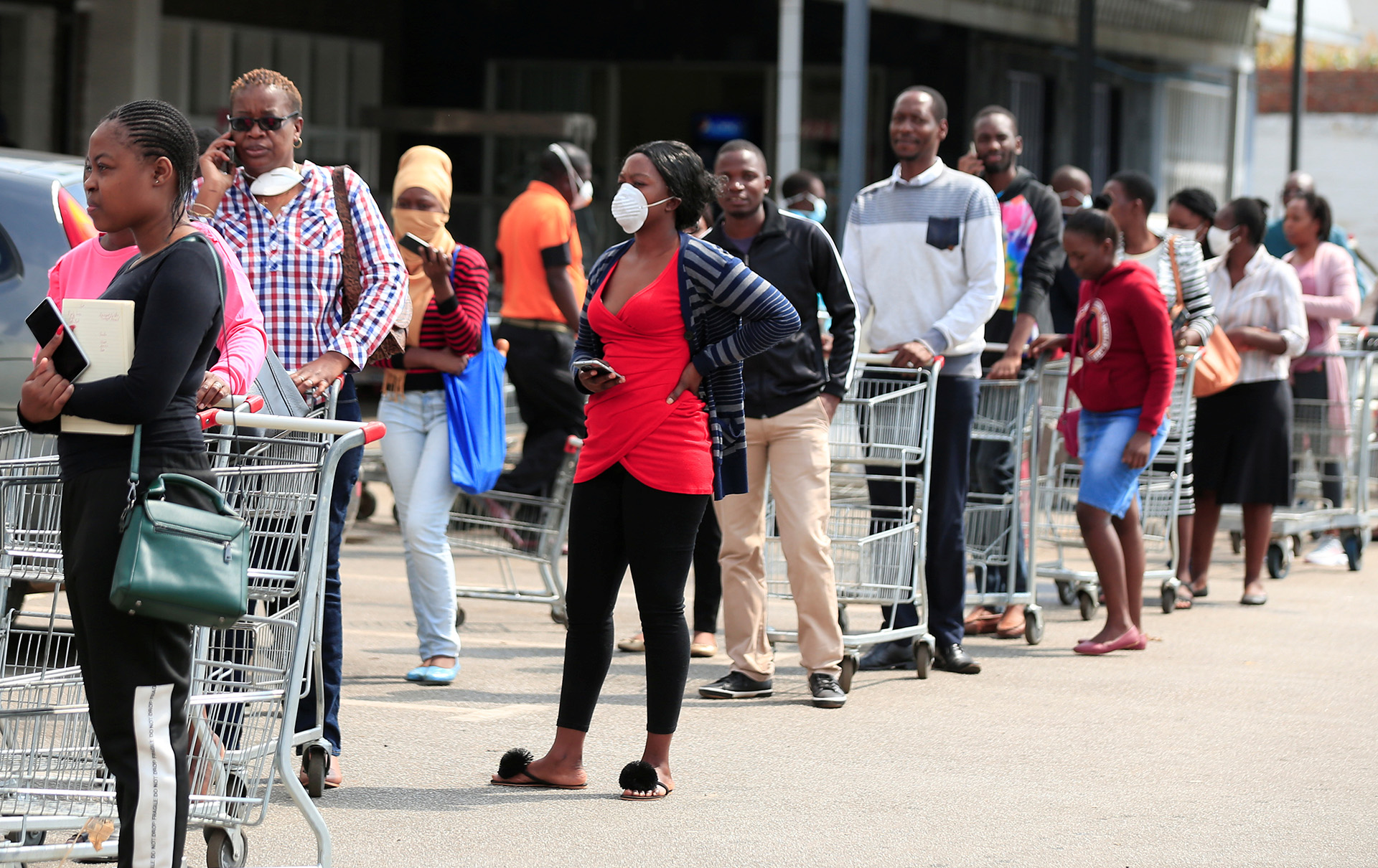 People in a shopping queue ahead of a COVID-19 lockdown in Harare