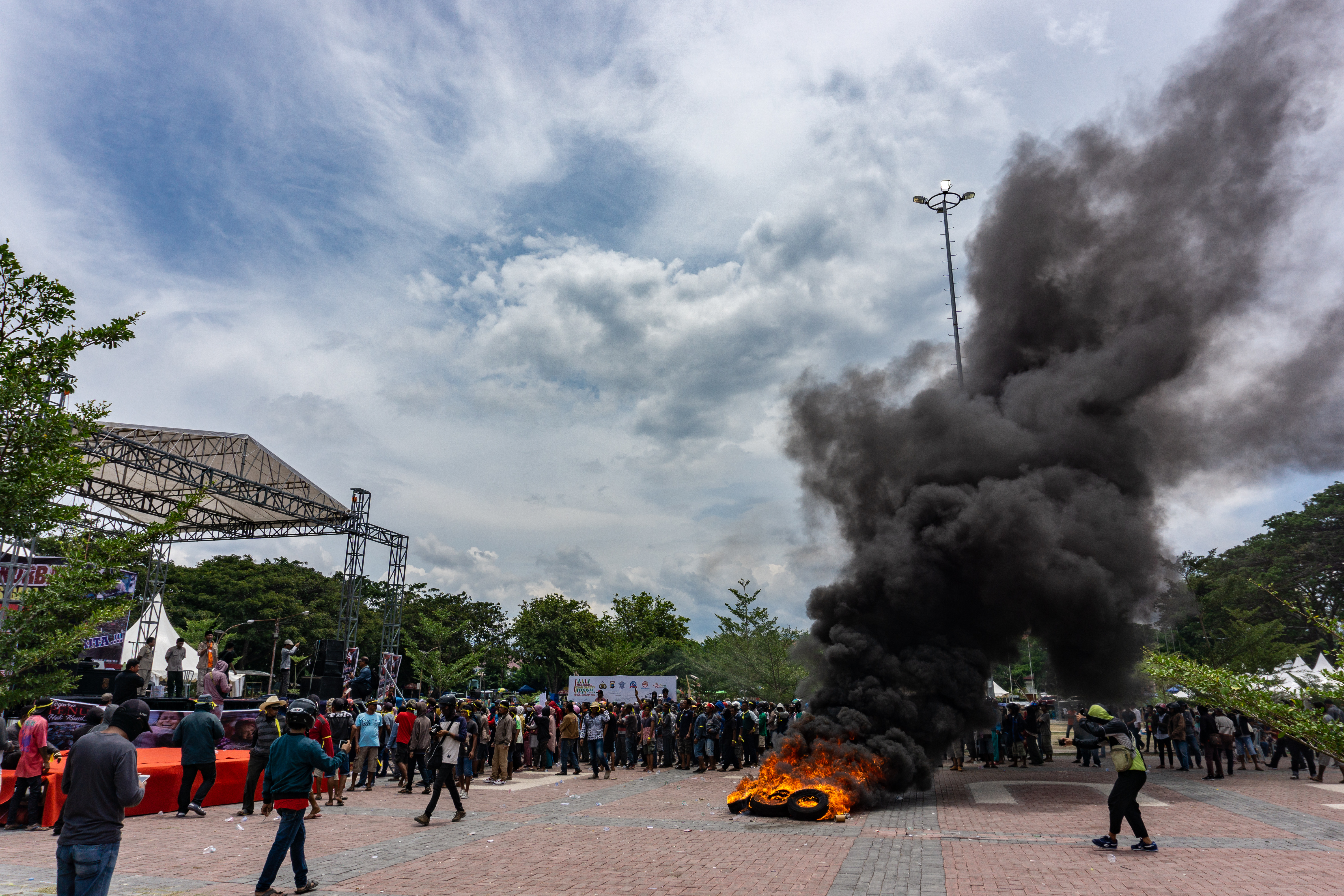 Protesters burned tires outside Palu mayor's office