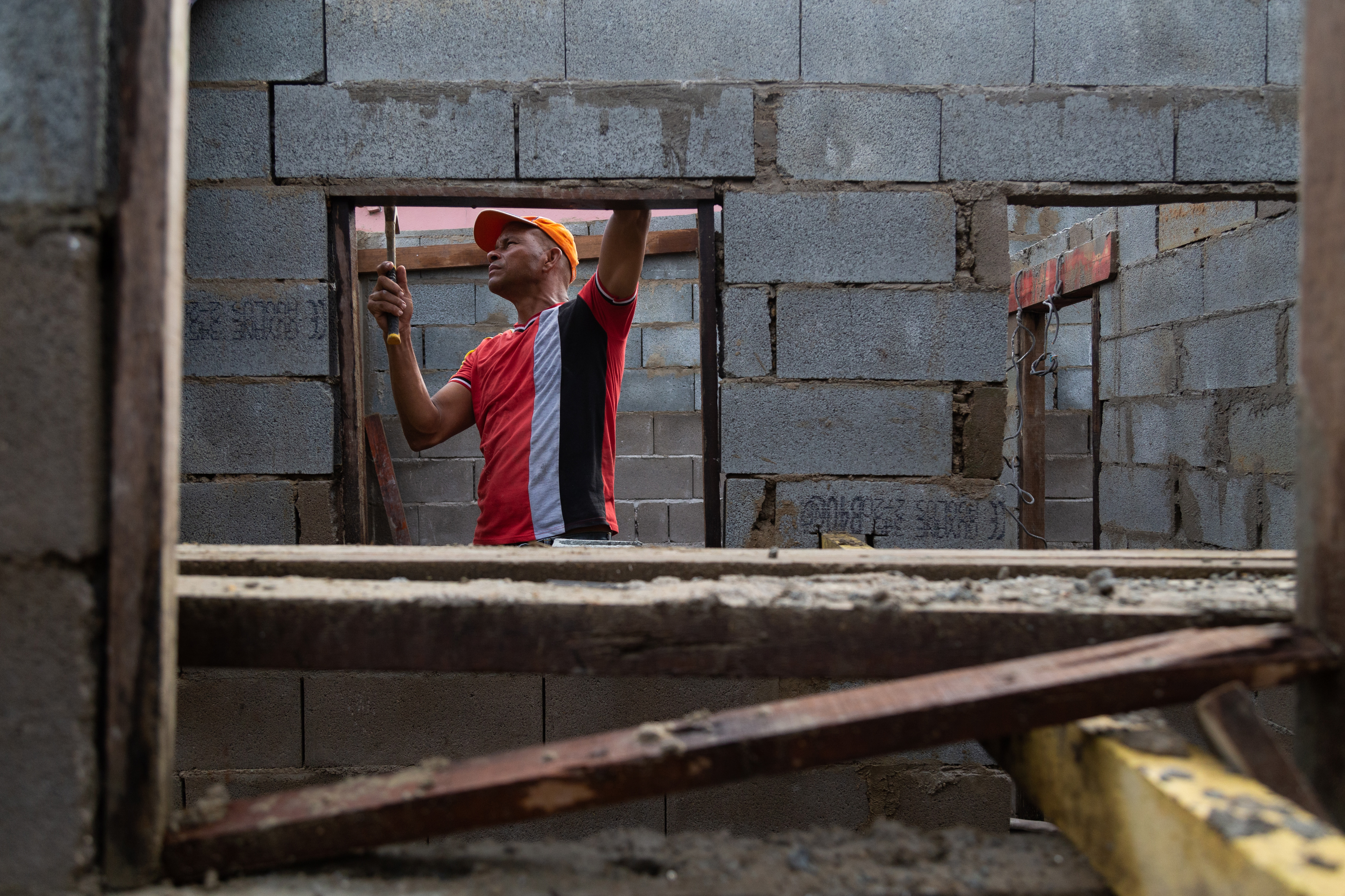 A Cuban migrant worker is pictured working inside a building.