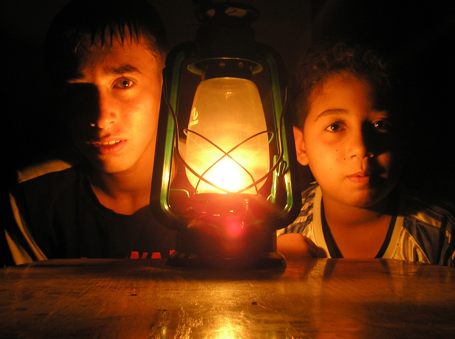 Ahmed, 14, and Amjad, 12, during a power cut in Tal Zaatar, Gaza