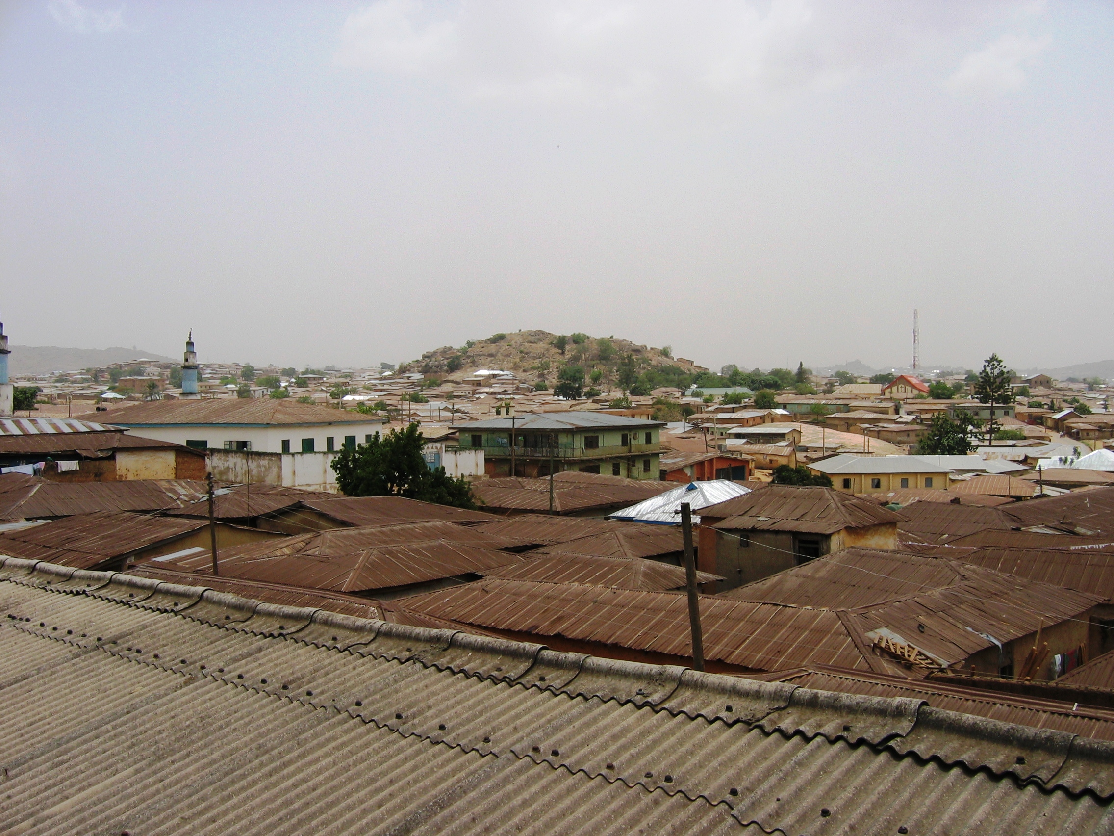 The mosque with the blue minaret (left) in Jos's dense Congo Russia neighbourhood is now the landmark for the explosion of religious tensions in 2001, Nigeria, 4 April 2007. The trigger for the flare-up was a wrangle between Christians and Muslims after a