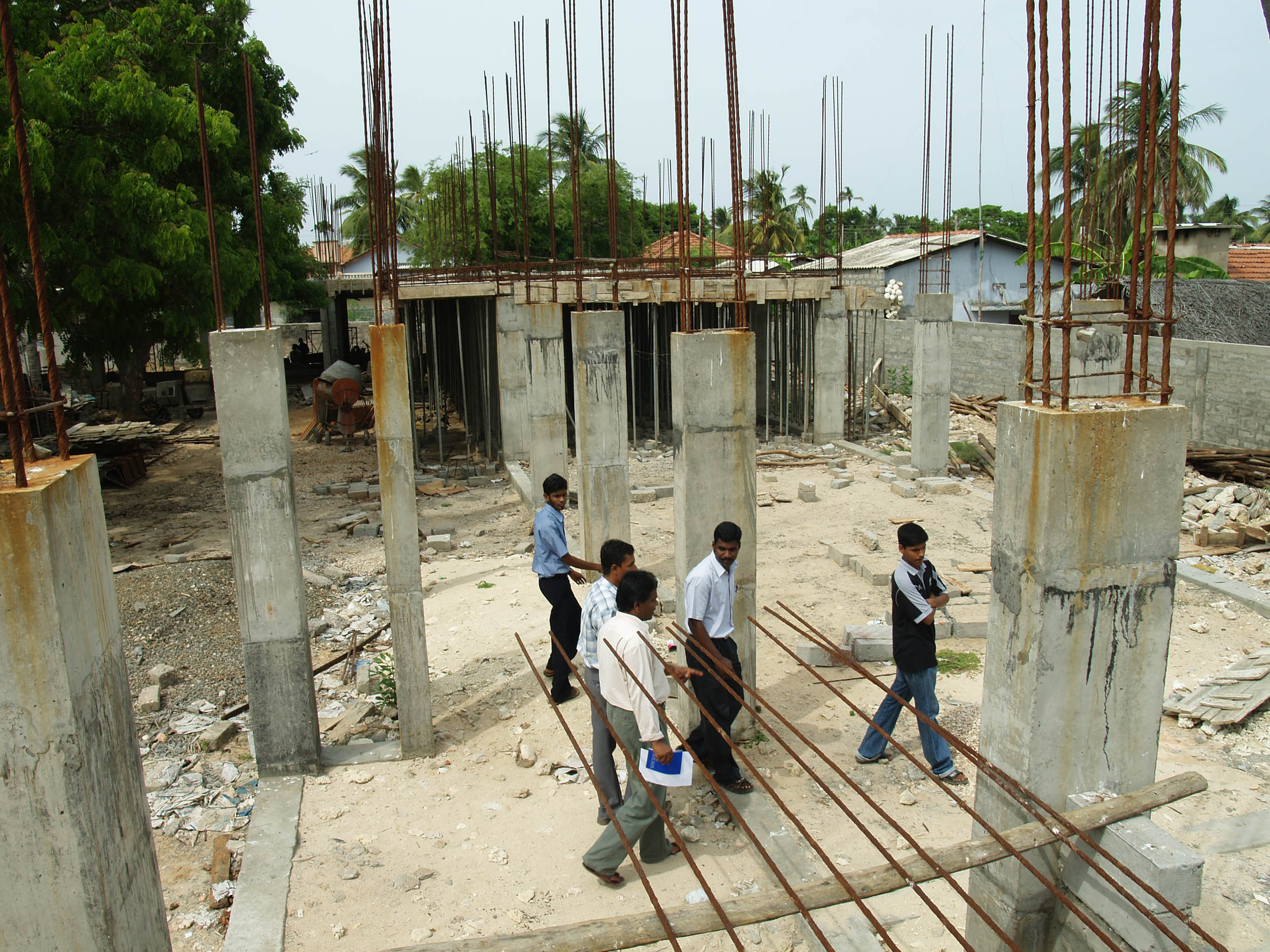 UNICEF and UNOPS staff tour the construction site for the Valvai Sivaguru Vid school in Point Pedro, Jaffna District. UNICEF is financing and UNOPS is building the school and one other in the area. Construction has faced many delays due to the security