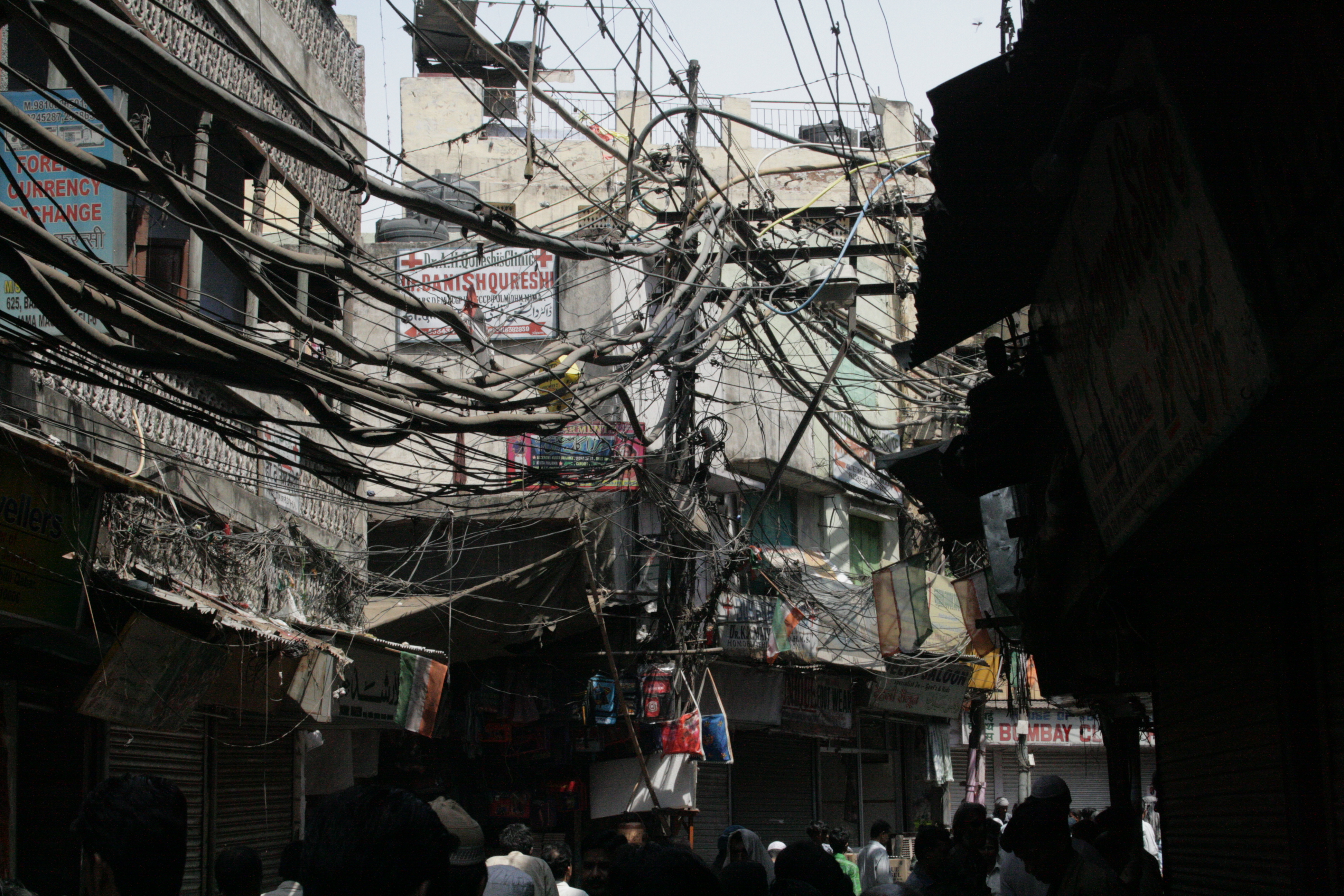 When infrastructure is not provided, or not affordable, the urban poor find their own way around the problem, as in Delhi, India, where electricity is tapped.