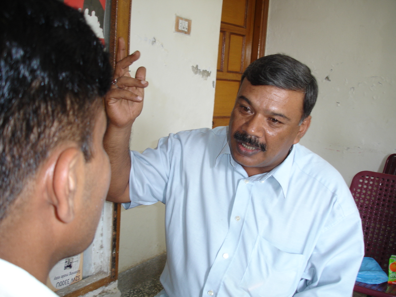 Brian Miller, field coordinator for Pakistan's Organisation for Social Development explains the risks of HIV to a visiting MSW at their centre.