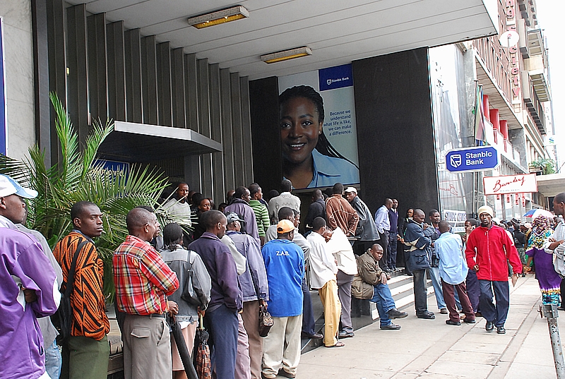 Zimbabweans queue for cash outside a Harare bank.