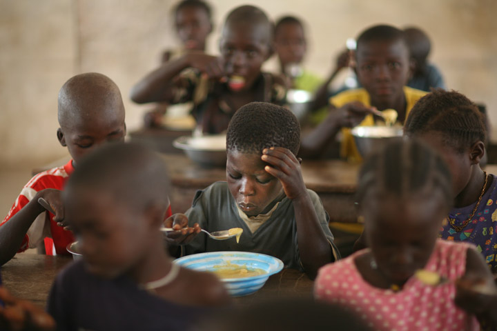 Pupils eat food donated by WFP in a classroom in Eva Orango school in Orango Island of Bijago Archipelago in Guinea-Bissau Feburary 2008. According to World Food Program (WFP) intellectual levels rise when children are fed properly.