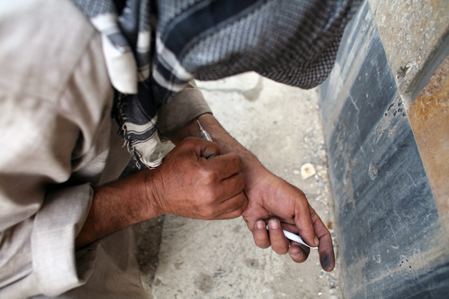 A Drug addict injects heroin in the ruins of former Soviet cultural center in Kabul Afghanistan, June 2008.
According to the most recent UN figures in 2005, there are about one million addicts in a country of about 30 million people.