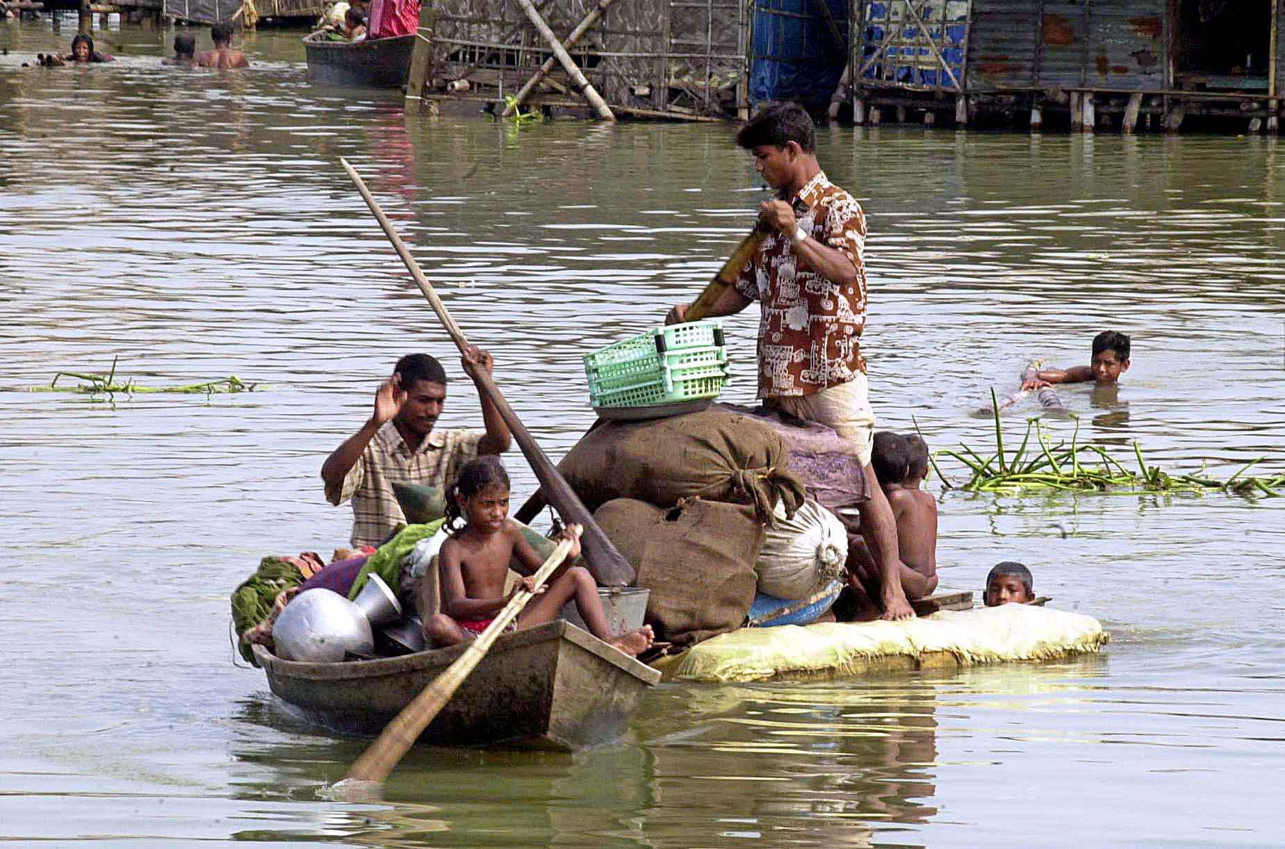 Shifting to a flood-free area by raft in Rangpur, north-western Bangladesh.