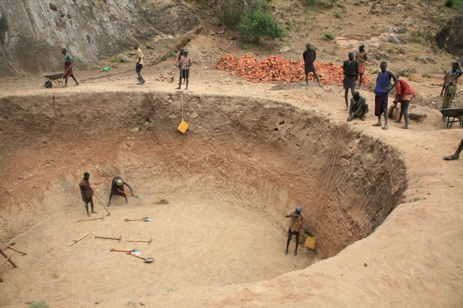 Several NGOs and other organizations are trying to do development projects in Karamoja, like this one, where men are paid to build rock catchments for holding water. The Karamoja region of Uganda, near the border of Sudan and Kenya, has not seen as many d