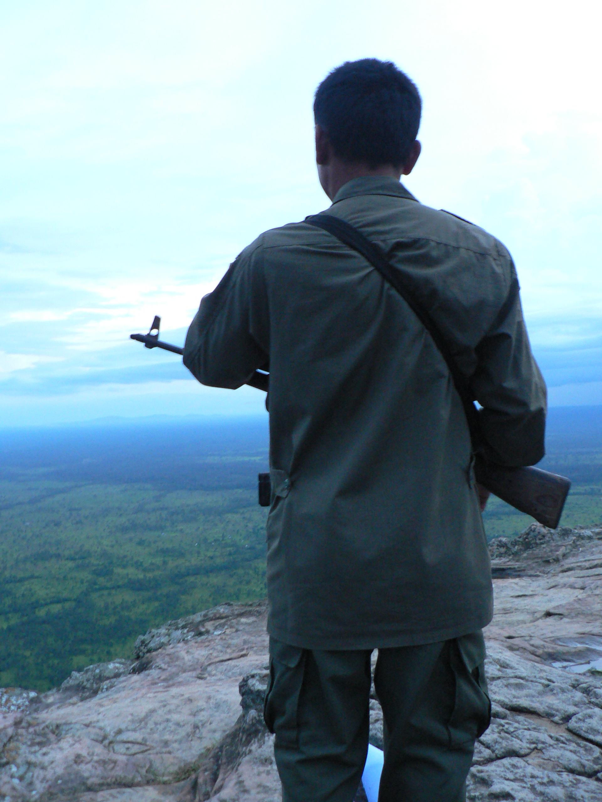 A Cambodian soldier stands guard along the Thai-Cambodian border. Tension over ownership of an ancient Hindu temple in the area has left many area residents hoarding food items, heightening the risk of possible food shortages should the crisis escalate.