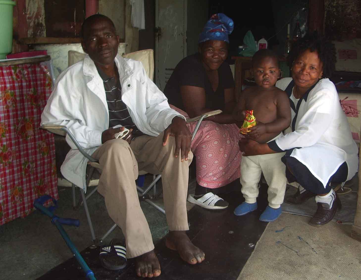 Home-based care-giver, Margaret Ndinisa visiting one of her patients and his family in Freedom Park, an informal settlement near Rustenberg.