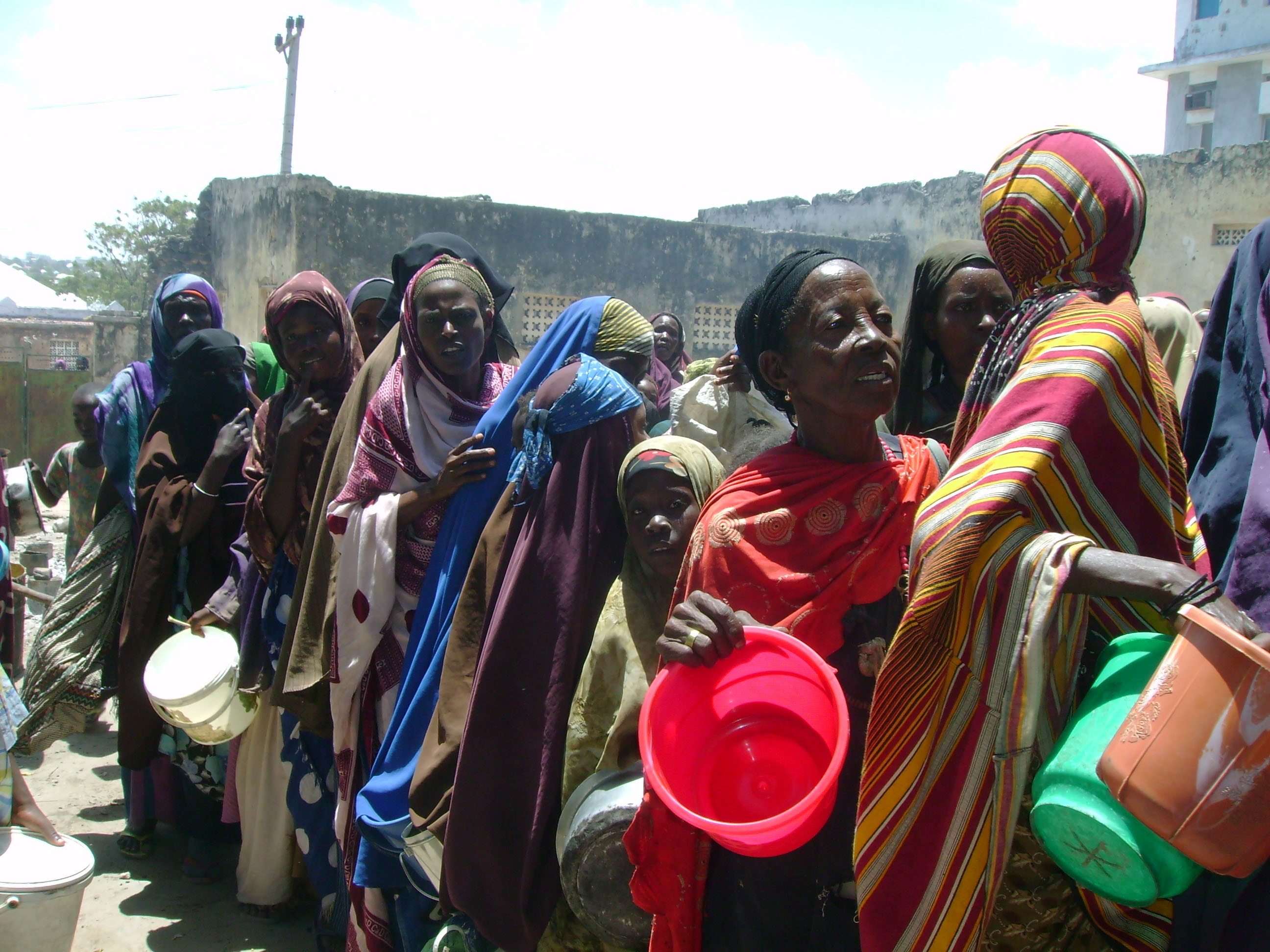 Displaced people wait to be given food during a distribution organised by the UN World Food Programme, USAID and other local and international NGOs, in Mogadishu Somalia on September 2008.