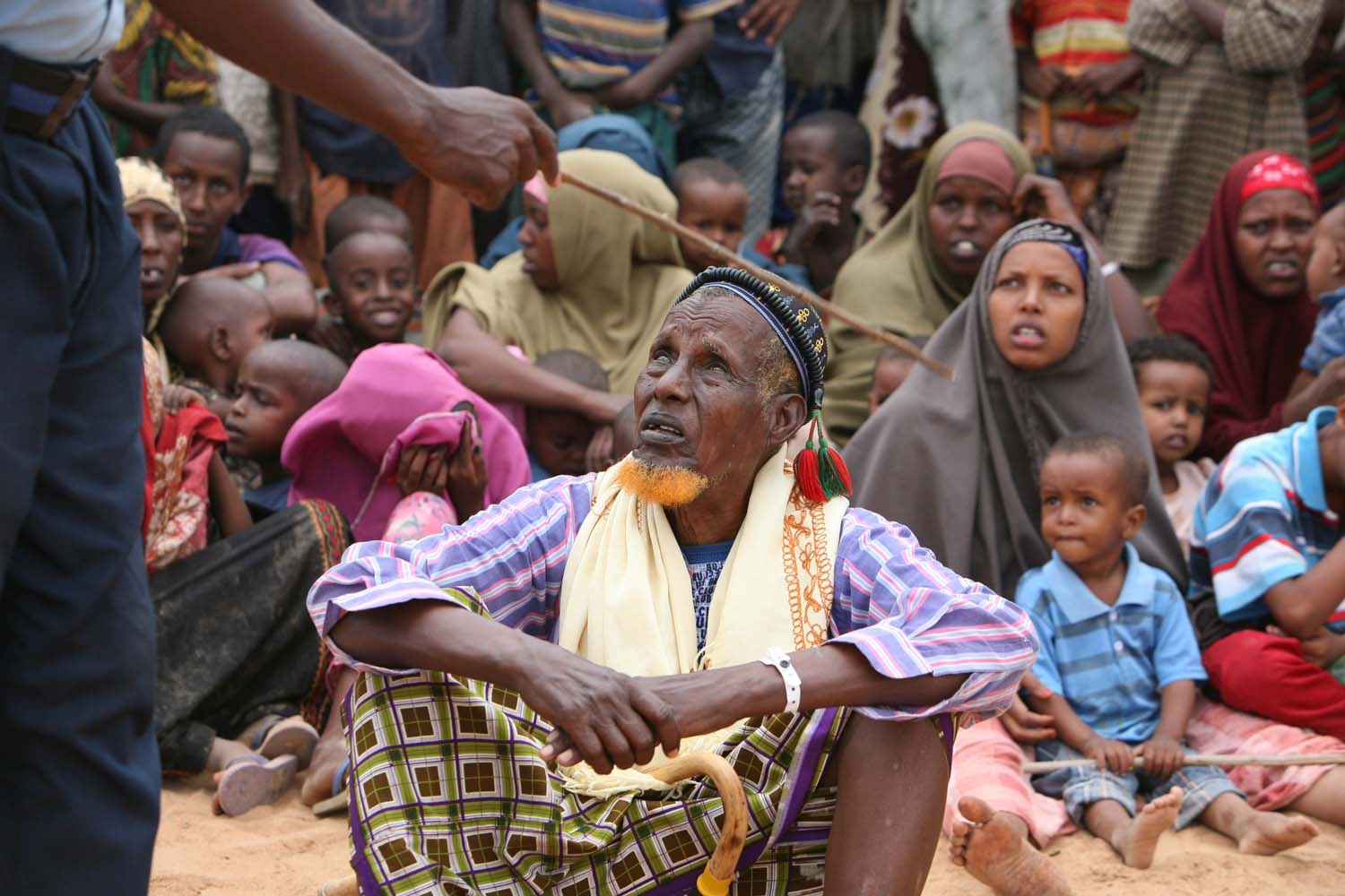 A group of newly arrived Somali refugees listens to instructions from a security officer in Dadaab, Kenya, October 2008. The conflict in Somalia has forced many people to seek refuge in northeastern Kenya.
