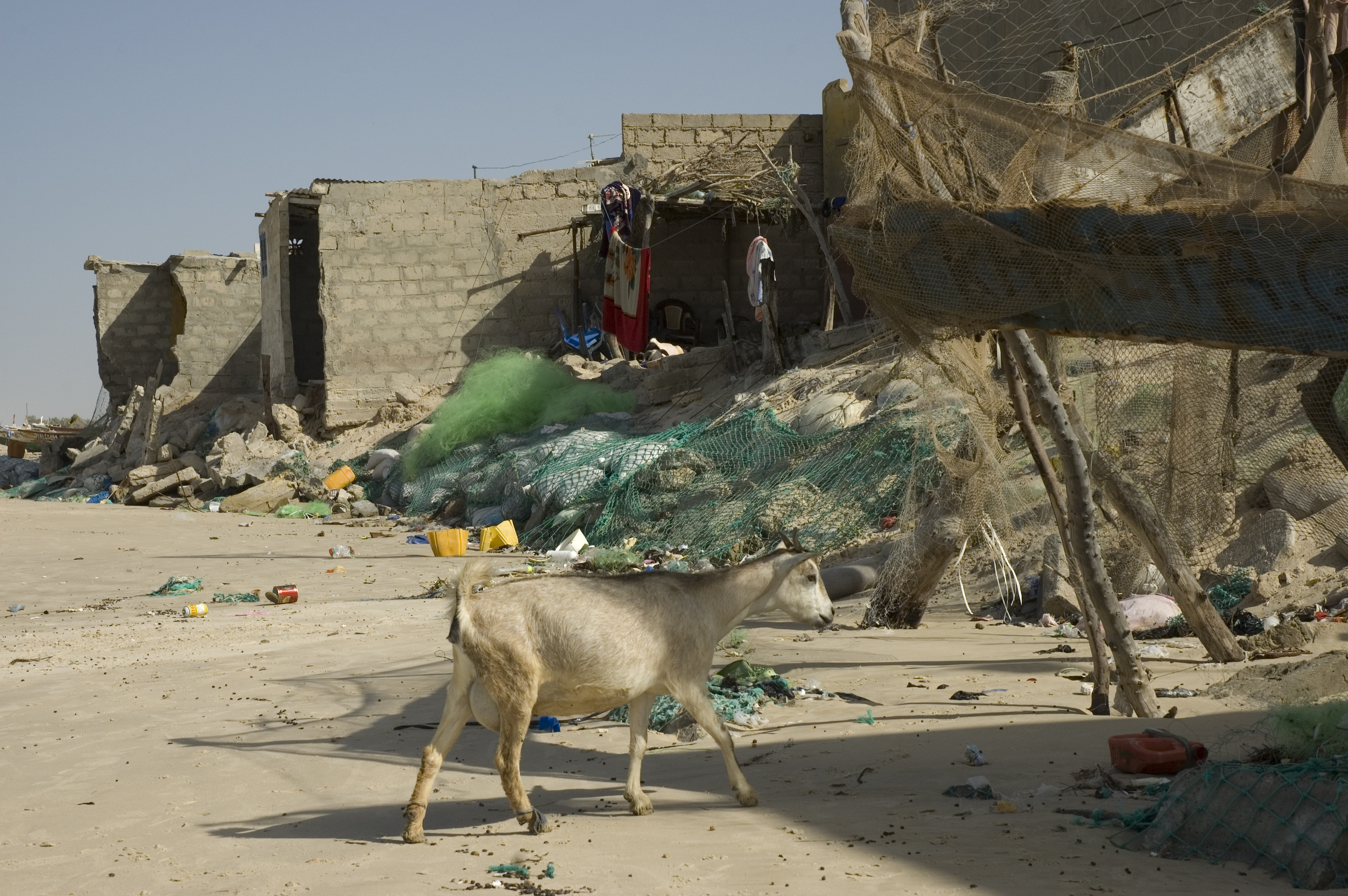 Residents in the Langue de Barbarie section of Saint Louis create rock or sand bag barriers to hold back the advancing sea