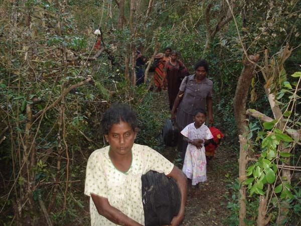 Civilians escaping to government controlled areas travel through the jungle, attempting to avoid being injured by artillery fire and trying to avoid the Tamil Tigers who do not want them to leave the conflict zones