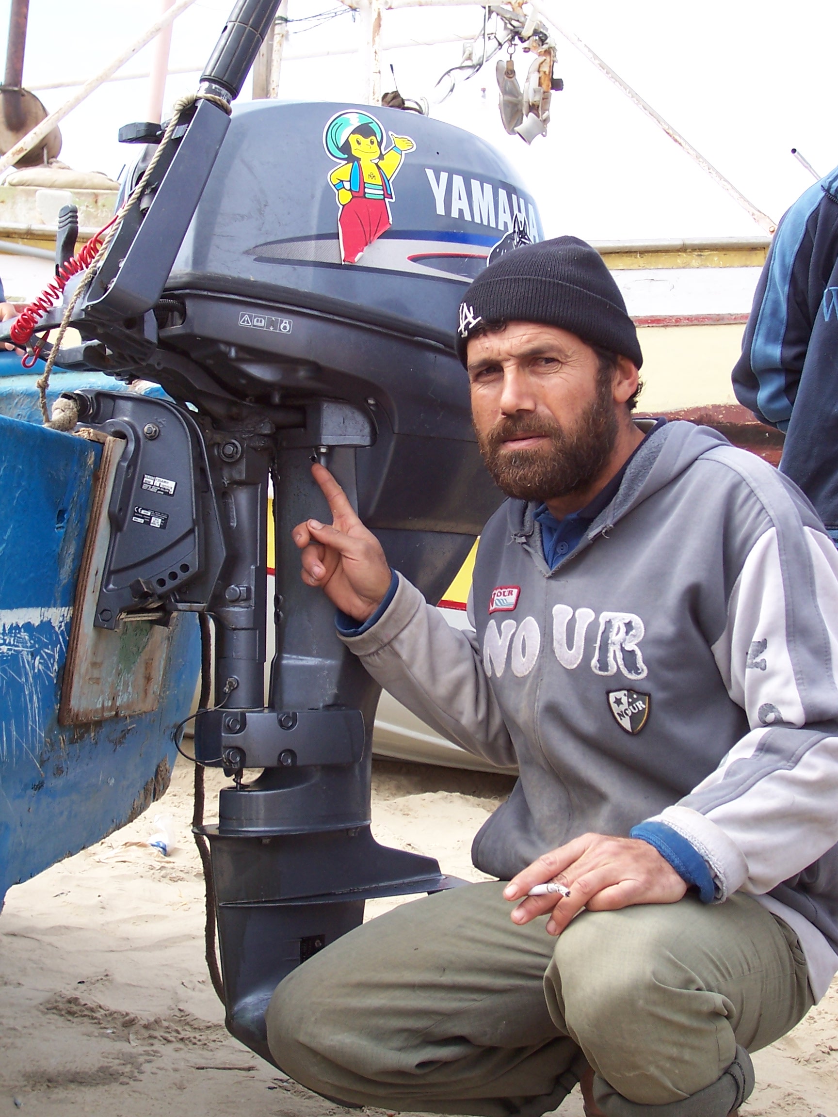 A fisherman at the Gaza City marina points to the bullet holes in his boat engine. He said he was attacked by Israeli gunboats while fishing