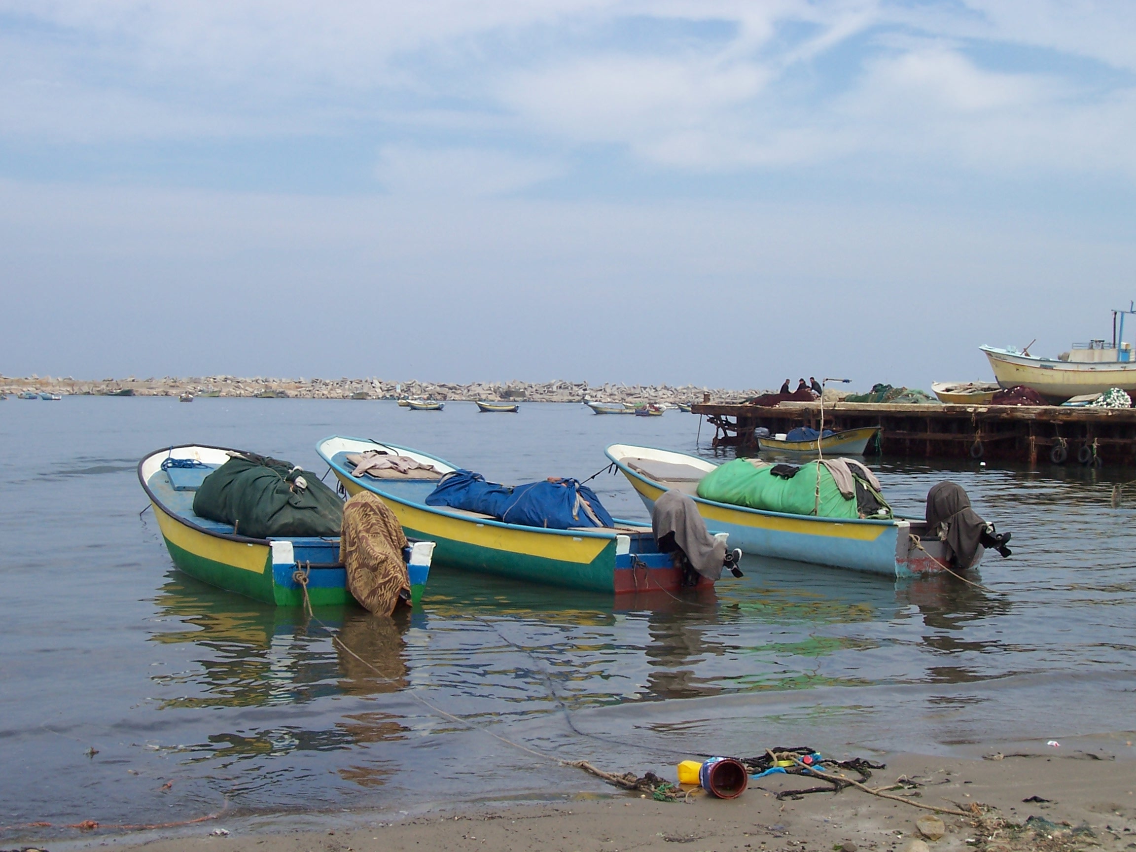 Fishing boats at the Gaza City marina. The rubble in the background has been transferred from areas in the Gaza Strip that were heavily bombed during Israel’s military campaign ending on 19 January 2009