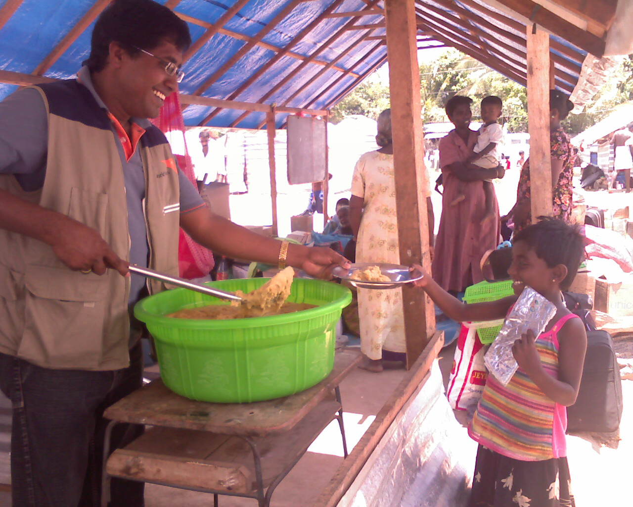 A young girl receives food assistance at an IDP camp in northern Sri Lanka. The nutritional status of thousands of children in the camps is a source of concern for aid workers on the ground