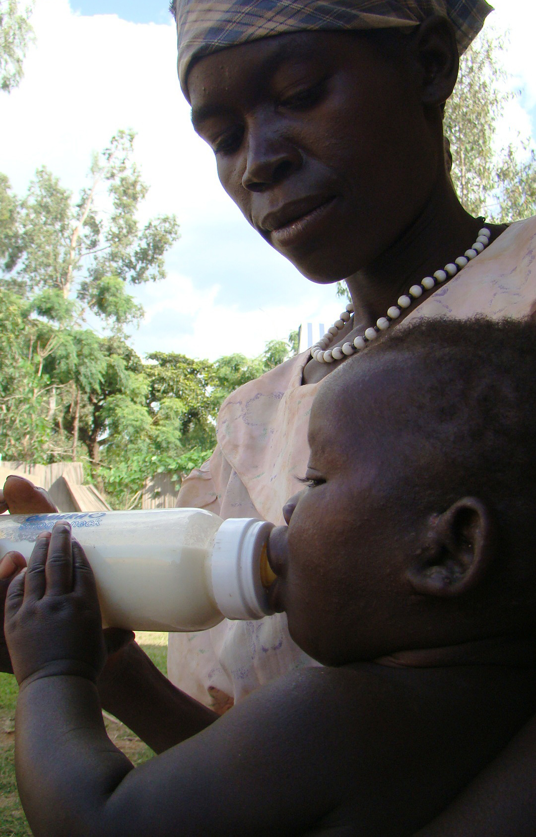 An HIV-positive morther in Gulu, northern Uganda, gives her baby cow's milk as a replacement for breastmilk in an effort to prevent vertical HIV transmission