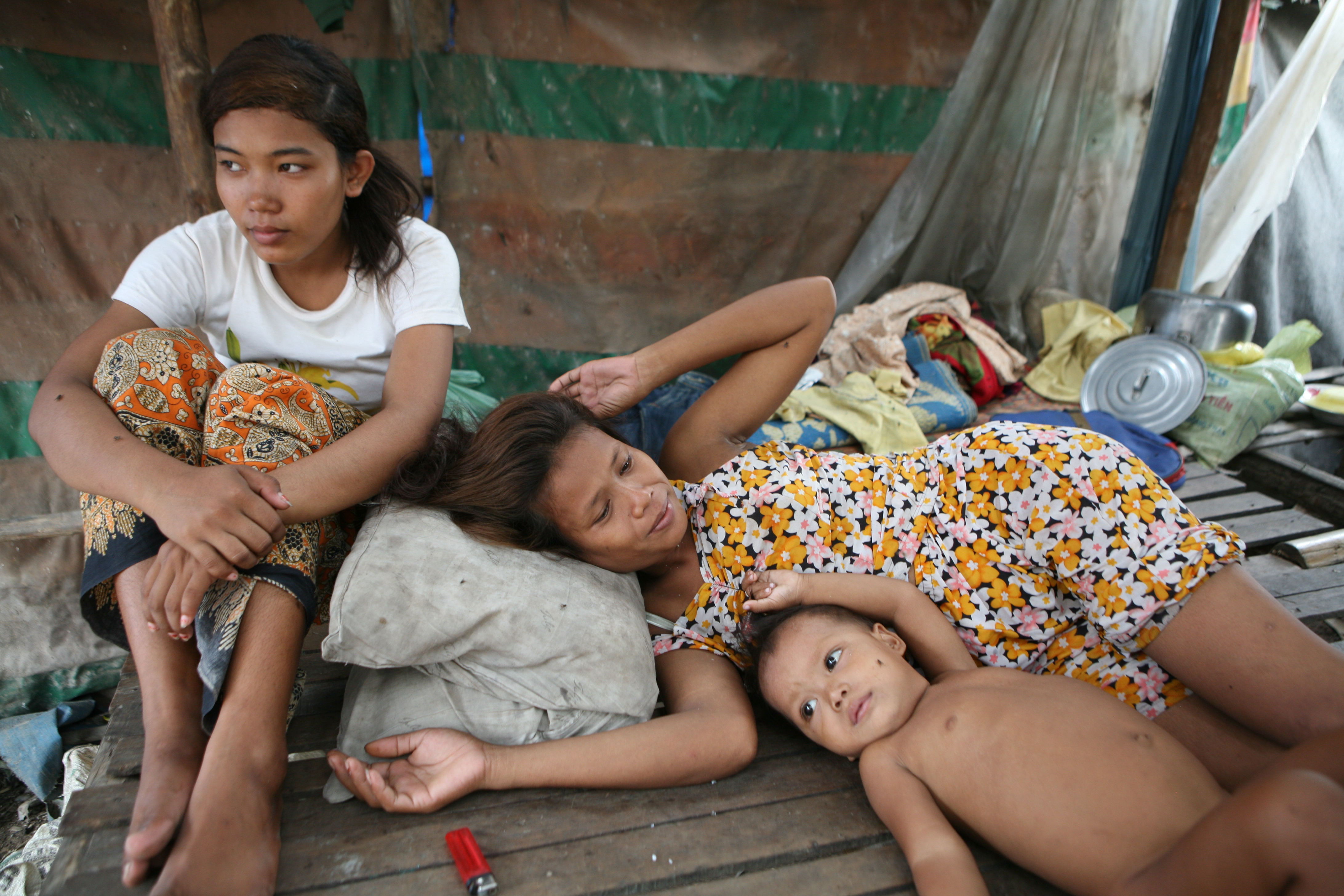 Displaced Cambodian women relaxing in their home