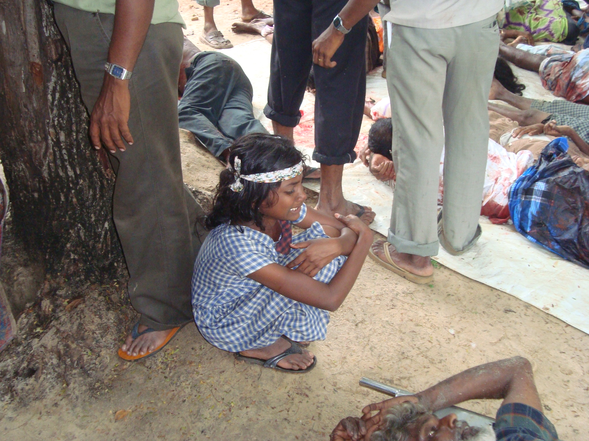A young girl cries amongst the injured in the final days of the conflict. Children were often the biggest victim of the 26-year-old conflict