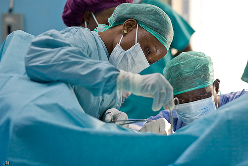 Female doctor performing an operation to correct Fistula