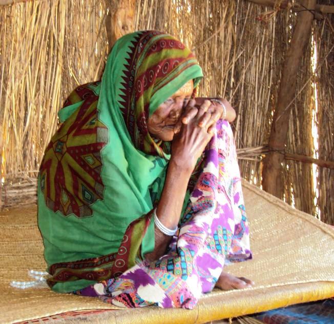 A woman in a camp for mainly Eritrean refugees in the east of Sudan. Born 1939 in Eritrea. Sitting in her home in Wad Sharifey camp. She fled Eritrea 1988 with her son and his wife
