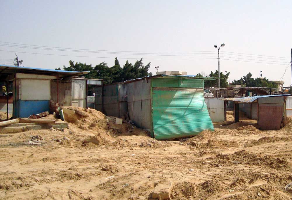 Huts built in a floodwater gully. People living in these are the worst affected by floods