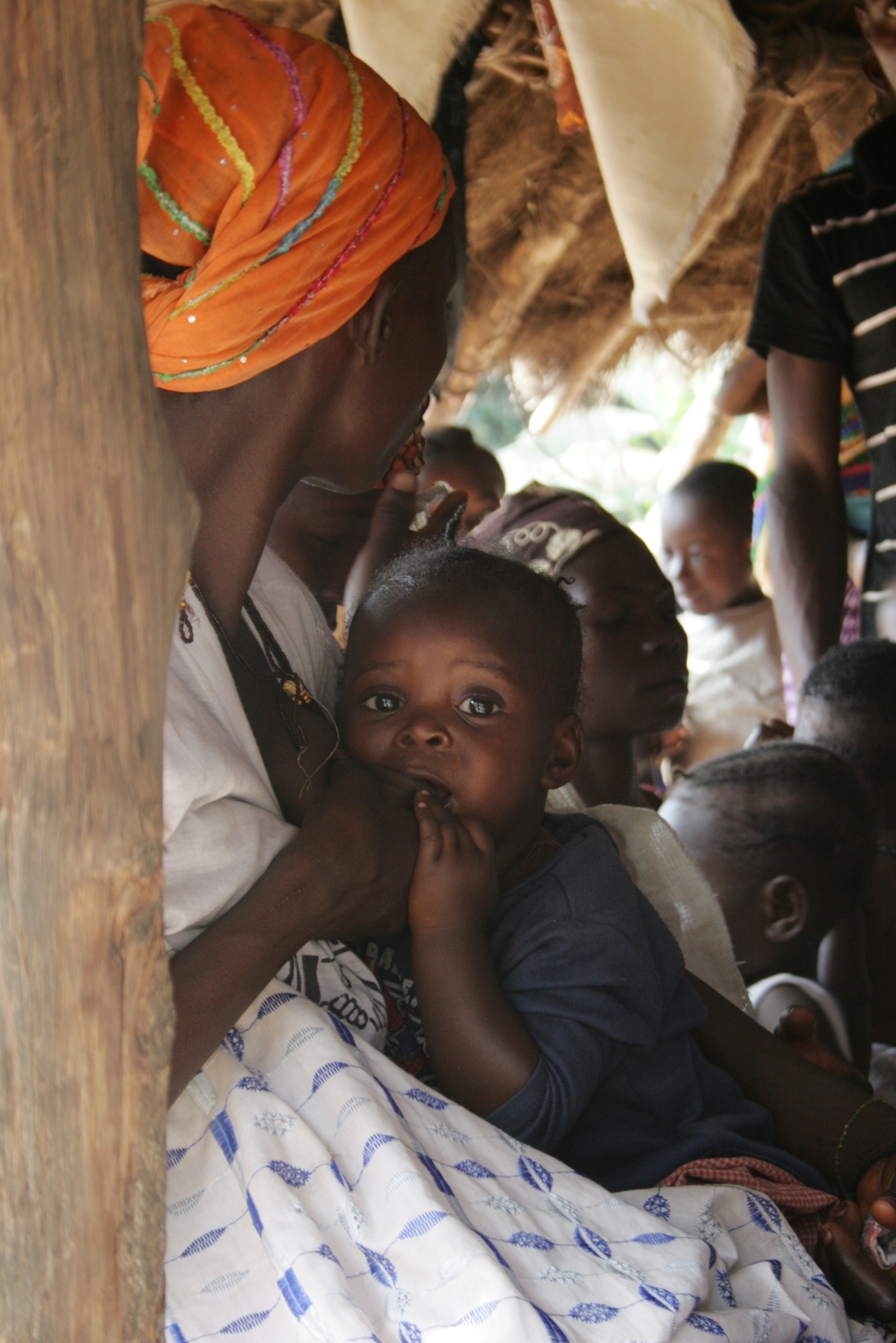 A woman breastfeeding her child in a village near the town of Makeni, Sierra Leone. February 2010