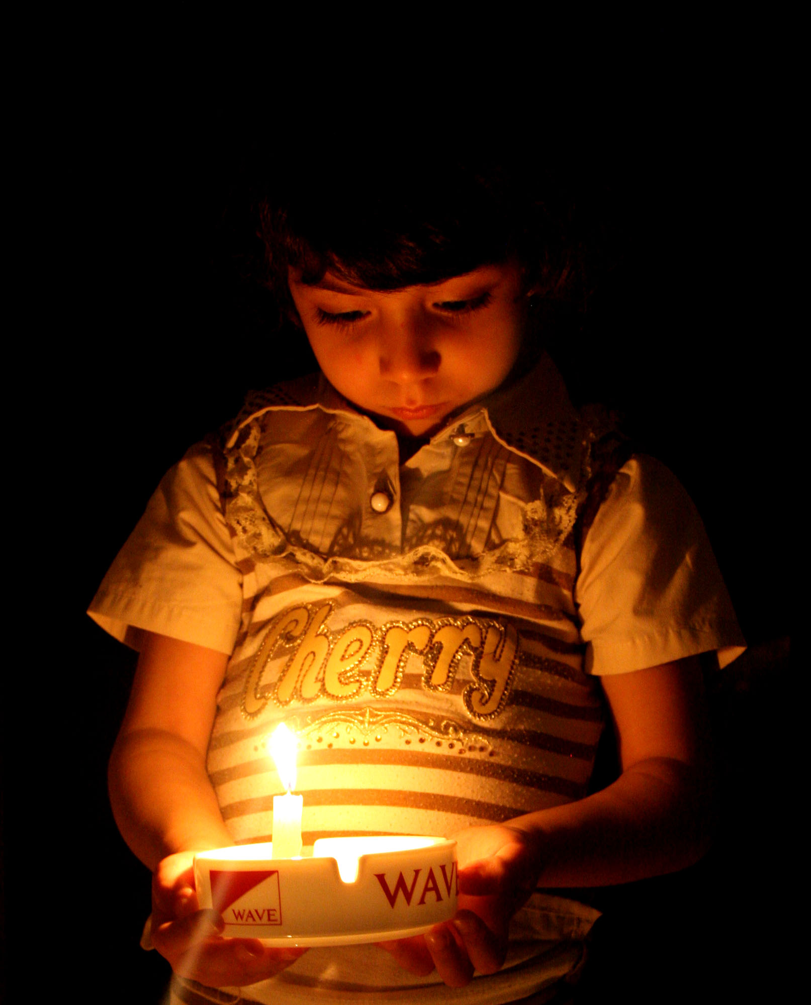 Hiba Salman,4 years, a Palestinian refugee holds a candle in her house in Khanyounis refugee camp southern the Gaza strip. Gaza suffers of daily power cut due to fuel shortage