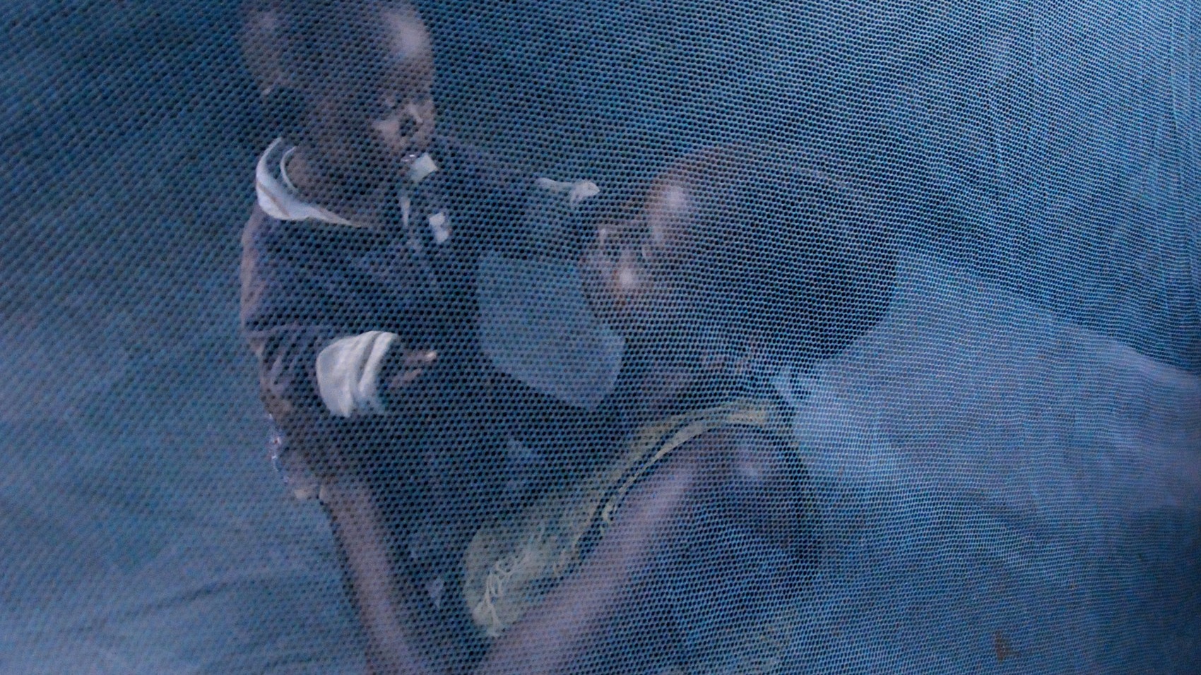 Mother and child under a mosquito net. Malaria. For generic use