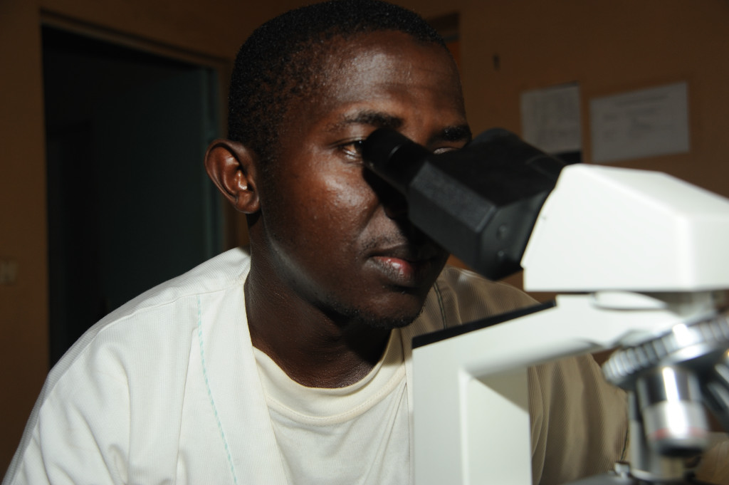 Rachadj Attoumane, who heads up the malaria surveillance programme in the Comoros island of Moheli, inspects a specimen for malarial parasites